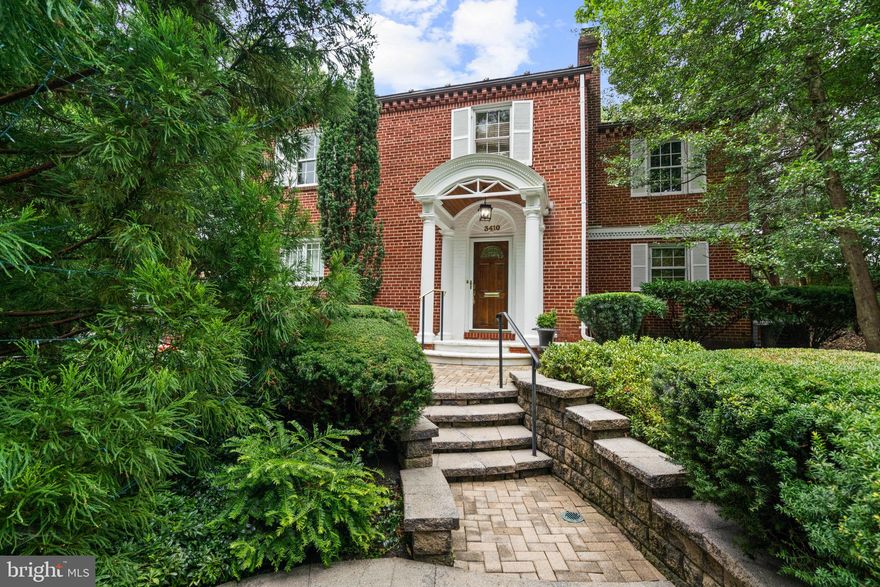Nestled on a sprawling serene property with mature flowering trees and boxwood bushes, this quintessential brick home is ideally located in the sought-after Village of Martin’s Additions. Featuring intricate exterior details, including dental molding, stunning oversized windows, a tiered stone walkway to a soaring arched covered entry porch with stately columns. Offering elegance, comfort, and an effortlessly livable layout with three bedrooms, three-and-one-half baths, and 3,150 square feet of finished living space across three levels, this home blends classic character with thoughtful updates designed for modern living.

The main level invites warmth with an inviting formal living room featuring a wood-burning fireplace, as well as access to a side study with views of an outdoor fountain. A second covered front entrance opens onto a butler’s pantry with wet bar and beyond to the state-of-the-art kitchen, creating excellent flow. The heart of the home is the generously-sized family room drenched in natural light with gorgeous, unique windows. There is a gas fireplace and access to a lovely brick patio and terrace, which overlook the expansive, manicured, beautifully tiered backyard, complete with a fence and storage shed. A lovely powder room, as well as a main-level bedroom (or office/den) with a full ensuite bath offers flexible separate space for guests, working from home, or a quiet retreat. All ideal spaces for everyday living and gatherings, as well as grand entertaining. 

Upstairs are two bedrooms, each with full ensuite baths, including the primary suite with a walk-in closet and built-in wardrobes and dressers. There is a floored attic above for ample storage. The lower level features a recreation room, laundry, and more storage. Private parking with an attached driveway.

Mere steps to the local park, Brookville Market, and La Ferme restaurant, 3410 Shepherd Street is sited in one of Chevy Chase’s most cherished communities—where tree-lined streets, timeless architecture, weekend strolls to Avalon Cinema or Rock Creek Park, and a close-knit feel define daily life.