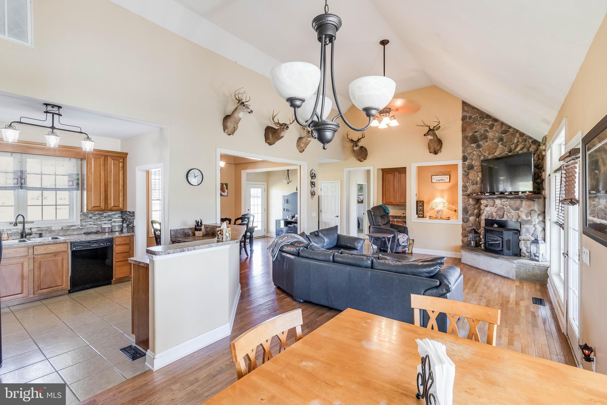 Welcome to this beautifully maintained traditional Cape Cod-style home! Step inside to an inviting open concept floor plan, seamlessly blending the living, dining, and kitchen areas. The living room features a stunning cathedral ceiling, hardwood floors, and a cozy stone surround pellet stove, complemented by built-ins that add character.
Retreat to the primary bedroom, complete with a tray ceiling, ensuite bath featuring a soaking tub and walk-in shower, and a spacious walk-in closet. Two additional bedrooms are located on the opposite end of the home, providing privacy and sharing a full hall bath.
Convenience is key with a separate laundry room offering garage access. Upstairs, a spacious bonus room awaits, complete with its own full bath, perfect for guests or playroom, or an additional bedroom.
Enjoy outdoor living in the fenced backyard, featuring a screened porch, above-ground pool, and patio—all set against a backdrop of trees, ensuring your privacy. The large front yard and attached garage, along with a long driveway, enhance the home's appeal. Additionally, the home is equipped with solar panels for increased efficiency. Don't miss this gem in a peaceful setting!