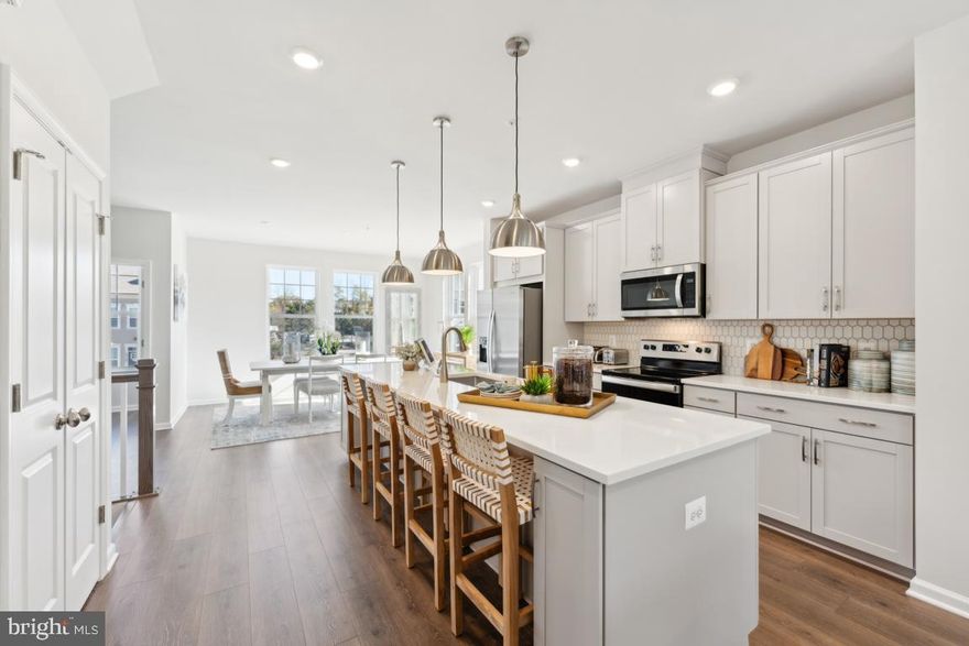 **NEW PRICE** MODEL HOME FOR SALE ! TOO GOOD TO BE TRUE MUST SEE!  This 3-level 22’ wide End Unit townhome offers 2,252 square feet of living space and features a front-loading 2-car garage with a long driveway, partial stone front, 3 spacious bedrooms, 2 full and 2 half baths, a finished rec room/den, and a rear composite deck. The spacious center kitchen with an 11' island, separate dining, and a great room with a linear fireplace, lends itself to this welcoming and open floor plan. Backs to trees! HOA includes lawn maintenance, snow removal, and trash pick-up. Conveniently located next to shopping, schools and public transportation.  Contact our Sales Representative for further details