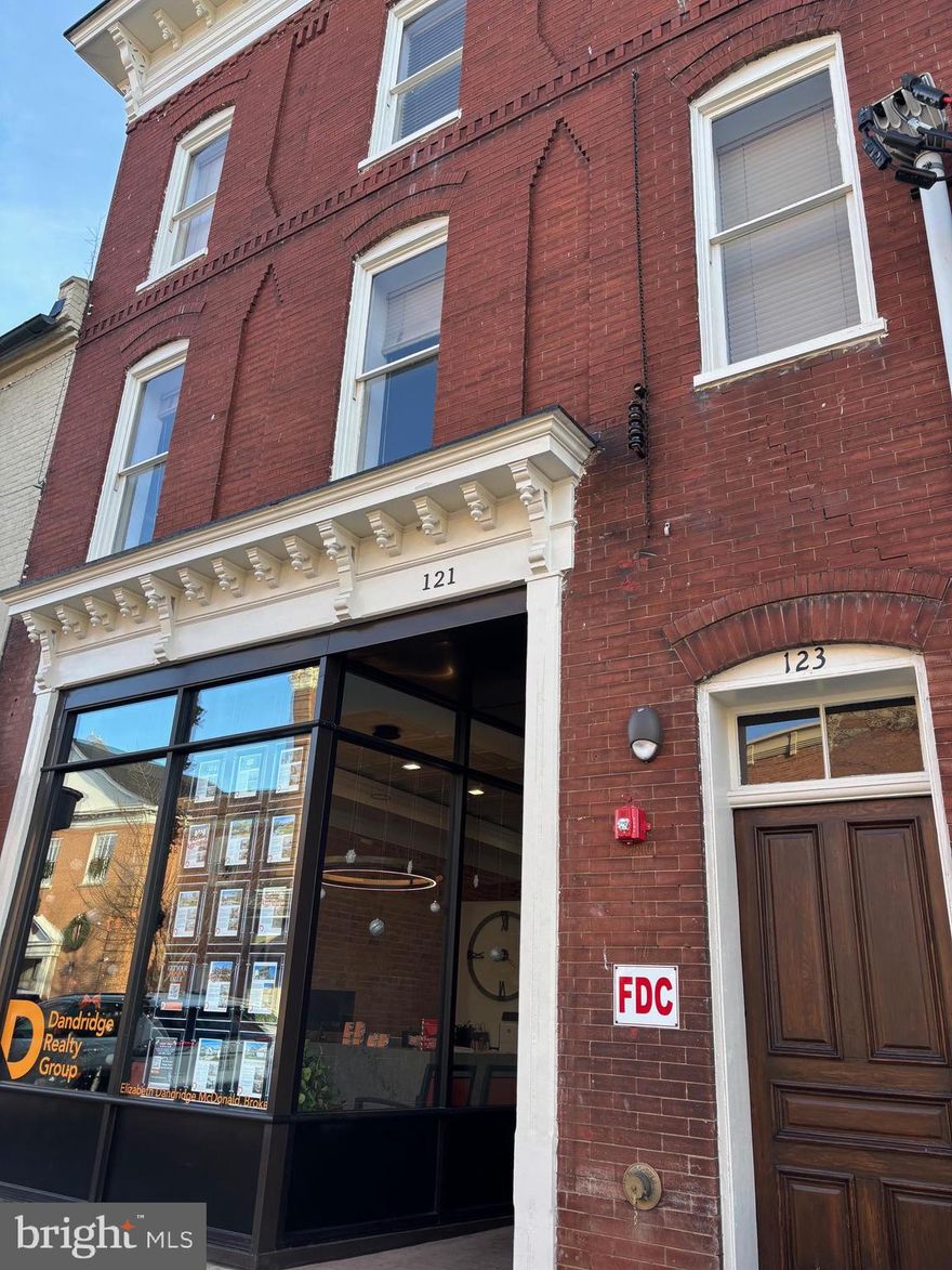 This is a brand new renovation of a historic property in downtown Charles Town, WV. The rent includes one 144 sq foot private office with locking door in a busy office environment.  Rent includes a private office, use of a full-time receptionist (8:30-5), conference room, training room, several lounge areas, and a shared kitchen. All utilities including dedicated fiber wifi also included. The office is located is a busy downtown business district with 2 coffee shops and several restaurants in addition to shops and the post office, all within walking distance. Rate includes utilities, building services and property expenses. Amenities include: 
Fully Built-Out as Professional Services Office
Fits 1 - 3 People
2 Conference Rooms
Finished Ceilings: 8’ - 9’
Space is in Excellent Condition
Plug & Play
Central Air and Heating
Reception Area
Wi-Fi Connectivity
Fully Carpeted
Drop Ceilings
Shower Facilities