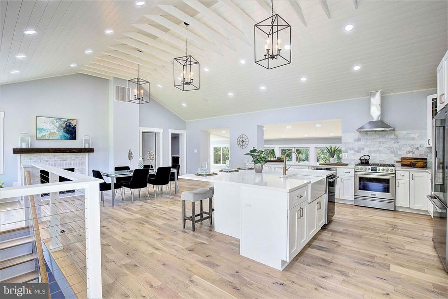 HUGE PRICE REDUCTION!! Stunning  waterfront situated on Crab Creek, quiet and perfect boating,  enjoying the water and for swimming. This home is 5 minutes from everything "Annapolis". There are 5 bedrooms & 4 full baths, with a main floor bedroom that is being utiized as an  office. Amazing property that offers water views from most of the main level. The dream kitchen has vaulted ceilings, an oversized island with seating for 5+, as well as stainless appliances, quartz countertops and views of the water! Three large accordion doors in the living room open up completely to let you transition easily to the large outdoor entertaining areas. Two master suites are located on the main level with an additional bedroom and full bath on the lower level. Separate laundry area/mud room on the main floor off the garage. Lower level has plenty of room for entertaining with a wet bar that leads out to a paver and flagstone patio and a huge HOT TUB that coneys with the home.  Roof and HVAC a few years old. So many custom features throughout this very special home