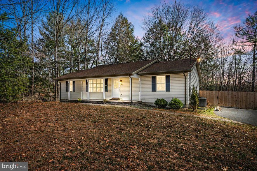 Discover this beautifully maintained one-level home nestled on a 1-acre lot in Hedgesville! This must-see property offers 3 spacious bedrooms, 2 full bathrooms and detached garage with a office, and space for a workshop, storage, or hobby space .The fully fenced backyard features a custom-built chicken coop and run, perfect for homesteading enthusiasts! Step inside to a bright and inviting kitchen with brand-new stainless steel appliances, butcher block countertops, a kitchen appliance closet, and a modern white tile backsplash. The primary suite boasts an updated, tiled walk-in shower.. New hot water heater for added peace of mind. Enjoy your mornings on the covered front porch or entertain guests on the back deck overlooking the expansive backyard with a 6-foot privacy fence. Don't miss this home, schedule your showing today!