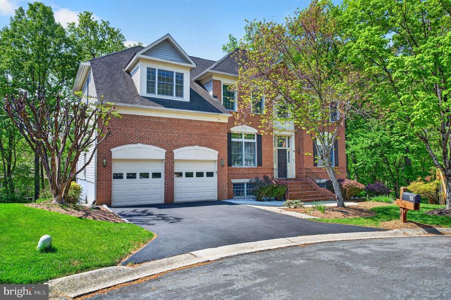 One of the largest and most unique floor plans in the sought-after Potomac Grove community! Ideally situated on a quiet cul-de-sac backing to trees, this stately brick-front Colonial offers over 5,400 finished square feet of beautifully updated living space.

This 5-bedroom, 4.5-bath home features a convenient elevator from the garage to the main level and up to the owner’s suite. A welcoming marble foyer opens to elegant living and dining rooms, while a private home office with large windows provides the perfect workspace.

The heart of the home is the stunning, refinished kitchen with upgraded finishes and high-end stainless-steel appliances, flowing seamlessly into the sunroom and dramatic two-story family room with skylights and a fireplace—ideal for both everyday living and entertaining. Step out onto the spacious deck, perfect for outdoor dining and gatherings.

Upstairs, the luxurious owner’s suite boasts a fully renovated spa-like bathroom, sitting area, and generous walk-in closets. Two additional bedrooms share a Jack-and-Jill bath with double vanities, while a fourth bedroom includes its own ensuite bath and built-ins.

The bright, walk-out lower level impresses with 12-foot ceilings, large windows, a fireplace, and two sets of doors leading to the patio—so inviting it hardly feels like a basement. A private fifth bedroom, full bath, built-ins, and abundant storage complete this level, along with a spacious workroom.

Additional upgrades throughout the home enhance both style and functionality. This exceptional property offers space, comfort, and modern updates in a prime location—truly a place to call home.