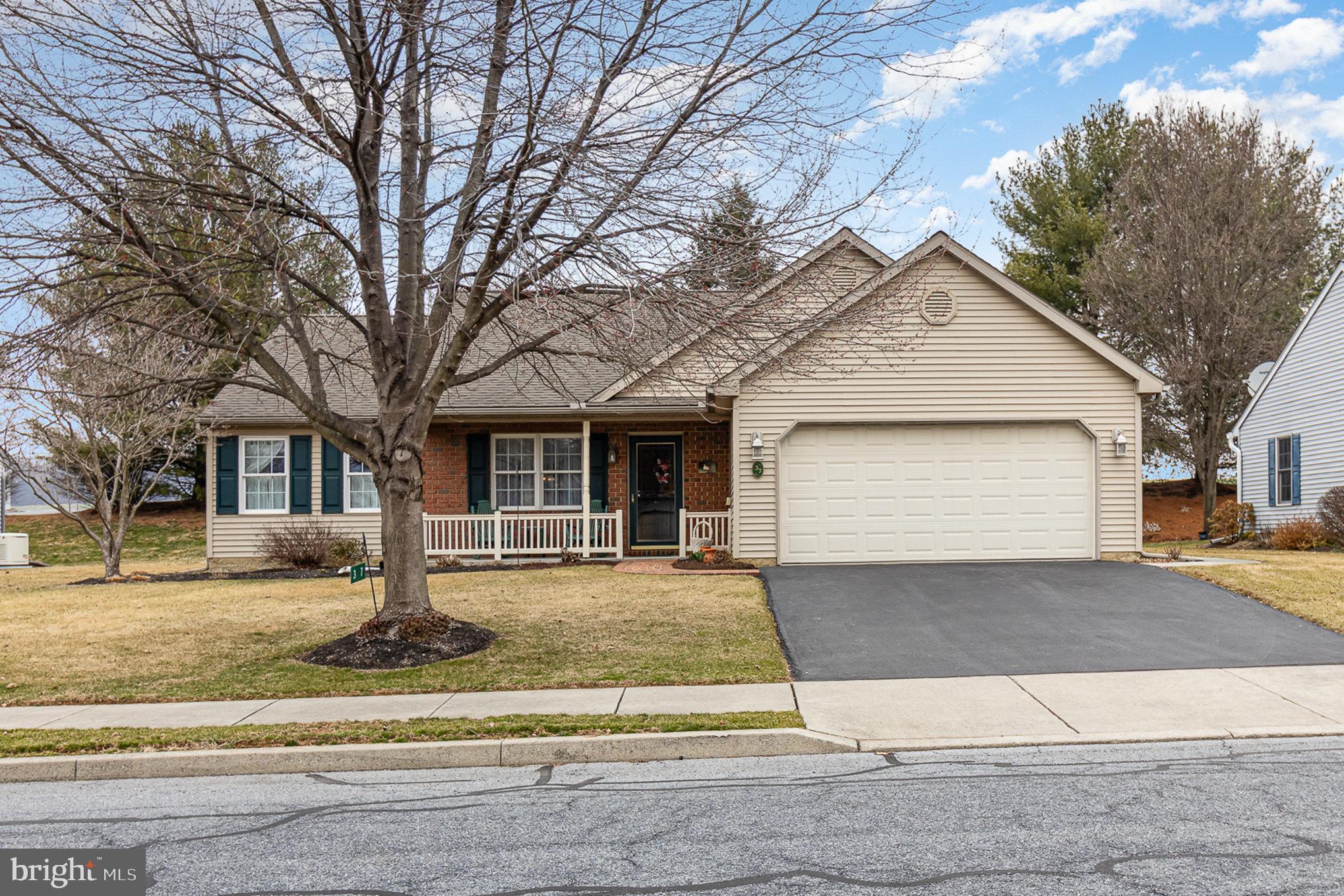 Discover the charm of single-story living, in this lovely home located in the desirable Arbor Gate community! Step onto the covered front porch and enjoy the charming view. Inside, you'll be greeted with an open floor plan featuring a cathedral ceiling in the living room, and a cozy corner gas fireplace. The dining room flows seamlessly into the kitchen featuring staggered cabinets, a corner glass accent cabinet, recessed lighting, and a convenient pantry. Retreat to your primary bedroom suite, complete with dressing closet and an ensuite bathroom (walk-in shower). Enjoy the flexibility of two additional spacious bedrooms, easily transformed into an office, den, or craft room to suit your needs. Main full bathroom has a tub/shower combination to ensure comfortable accommodations. Beyond the dining room, sliding glass doors lead to a screened-in patio with ceiling fan and an uncovered patio for grilling and sun-filled relaxation. This home is well equipped for comfortable living with central air conditioning (replaced in 2019), natural gas water and furnace for efficient heating & hot water, double hung windows, and a water filtration system. A large mudroom/laundry room with built-in cabinets and a utility sink is conveniently located off the attached two-car garage. Need storage? An upstairs storage room provides ample space. This tastefully painted, decorated, and well-cared for homes has a land lease of $425.19/month which includes usage and maintenance of common grounds & clubhouse, sewer, trash, and on-site management. Enjoy the clubhouse where you can join in countless activities and gatherings. Clubhouse amenities include a banquet hall, fitness room, billiards room, hair salon, library, coffee shop, game room, lake views & fishing, and gazebo all just a short stroll away. This house is convenient for everyday living, and is ready for you to make this home your own! Take a look at the virtual tour and call today see it in person!