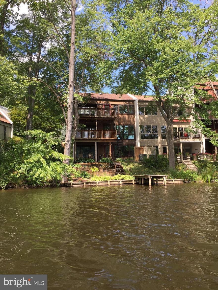 Price Reduced. Now over 200K below most recent sale. End unit with great potential! Stunning water views from all three levels of this lakefront end unit with garage. 4 Bed, 3.5 Ba with fenced courtyard, private dock, rear patio and decks on both upper levels. New roof and HVAC in 2016. Shows well but part of an estate and being sold strictly as-is.