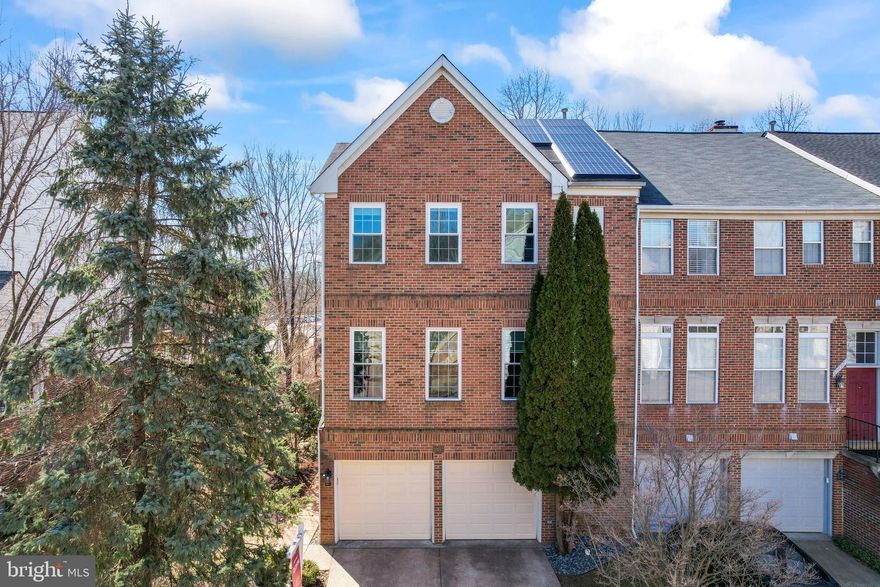 Discover this elegant 4-bedroom, end-unit brick townhouse with a 2-car garage, nestled in the heart of Lowes Island and backing to serene trees. Bathed in natural light, this home features fresh paint and gleaming hardwood floors throughout the main and upper levels. All new windows installed in 2023.
The main level welcomes you with a cozy gas fireplace anchoring the living room, a separate dining area, and a walkout to an expansive deck surrounded by lush greenery. The open kitchen is a chef’s delight, boasting granite countertops, a wraparound breakfast bar, stainless steel appliances, upgraded cabinetry, and gas cooking. Adjacent to the kitchen, a versatile space serves as either a charming dining nook or a cozy family room. 
Upstairs, the recently remodeled master suite offers abundant closet space and a luxurious en-suite bathroom with dual vanities, a stand-up shower, and a soaking tub. The upper-level bathroom has also been beautifully updated. The expansive lower level includes another gas fireplace, full bath, and opens to a patio and fenced backyard—perfect for relaxation or play.   Whole house Solar System included, electric utilit bill is about $35-$45 per month! See Elec consumption in MLS Docs. HVAC 10yrs, Roof 12yrs, Hot Water 8 yrs, Windows 3 yrs.
Enjoy the exceptional Cascades community amenities, including pools, parks, tennis courts, trails, pickleball, bocce, and a vibrant community center. Ideally located just moments from the Potomac River, Volcano Island Waterpark, Seneca Regional Park, Algonkian Park, and major commuter routes, this home is also within walking distance to the local elementary school and a playground right behind the property—ideal for pets and family fun. 
Proudly part of the Lowes Island / Seneca Ridge / Dominion High School pyramid, this townhouse offers the perfect blend of elegance, convenience, and community.
