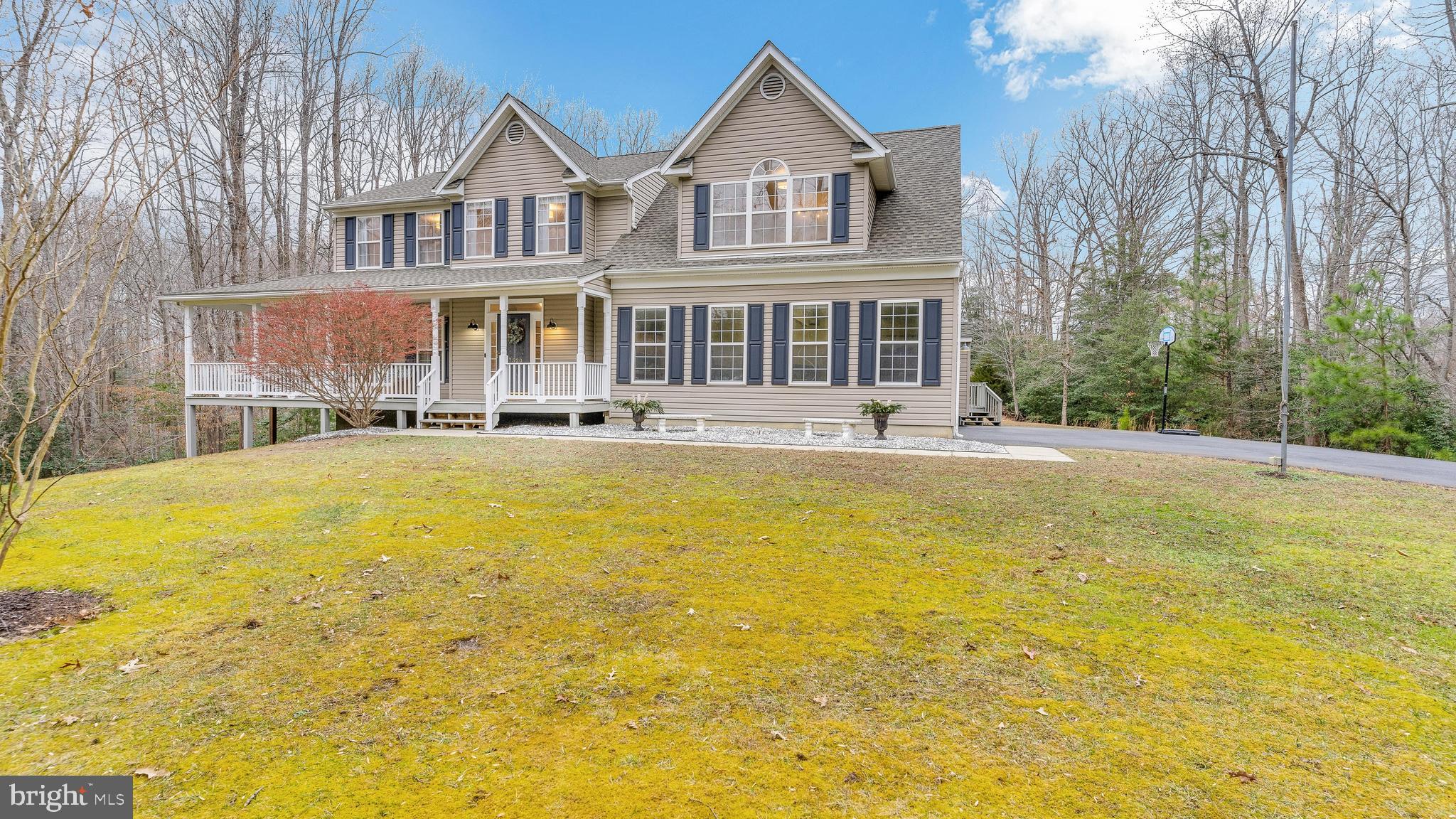 Welcome home! This spacious colonial home with two car garage attached, sits on 5.86 acres and is nestled on a bluff with your own walking trails and has a small creek around the base of the bluff, with lots of privacy and beautiful scenery, you have to see this one! The front has a wraparound porch with an eating area available. Large back deck that flows down to a concrete patio area. Four bedrooms and two and a half baths. Master bedroom is very spacious and includes an area for home office space with a view. The master bath is equally impressive with separate two headed shower and stand-alone soaking tub with two large vanities one on each side. Three walk-in closets in master suite and a secret room! Outside the master is a spacious laundry with washer/dryer and utility sink. Also has a pull-down attic access. The other three bedroom are all very comfortably sized, and one has two closets in the room. The main floor has a family room that flows to the dining room, and on into the kitchen. From the kitchen it flows into very spacious living room. All appliances are brand new stainless steel with new Quartz countertops. Full basement with walk out, that has a bathroom stubbed out and some walls framed. Separate detached large workshop with two car garage door and side entry. Both the roof and driveway were redone in 2020. This house has incredible storage space throughout! Come see quickly!
