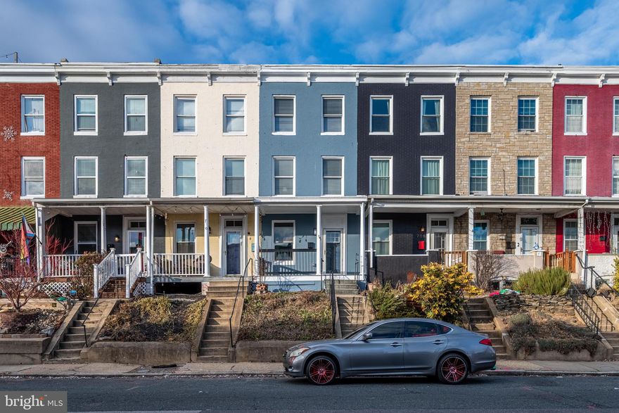 Welcome to this stunningly renovated rowhome in the vibrant heart of Hampden, perfectly situated at 708 W 34th St, one of Baltimore’s most iconic and celebrated residential blocks. World-famous for the annual Miracle on 34th Street holiday light display, this storied street draws visitors from near and far each year, transforming into a festive destination filled with tradition, charm, and community spirit. Opportunities to own a home on this legendary block are exceedingly rare—made even more exceptional by this home’s location on the highly coveted even side of the street, where the stately three-story homes sit elevated and proud. This remarkable residence offers the perfect blend of historic prestige and modern luxury. Inside, the home expertly balances classic character with high-end contemporary design. The sophisticated main level showcases an expansive open-concept layout with durable wide-plank flooring, recessed lighting, and a seamless flow ideal for both daily living and entertaining. The living area is anchored by a sleek, modern electric fireplace, while the dining space is elevated by a dramatic floor-to-ceiling natural stone accent wall that creates a striking focal point. The gourmet kitchen is a dream for culinary enthusiasts, featuring bright white shaker cabinetry with brushed nickel hardware, premium granite countertops, a gray subway tile backsplash, and a full suite of stainless-steel GE appliances. Upstairs, the serene retreats include spacious bedrooms with plush neutral carpeting and oversized windows that flood the home with natural light. The primary suite and additional living spaces are equipped with high-efficiency ductless mini-split systems, allowing for personalized comfort year-round. The beautifully updated bathroom offers a modern vanity with stone top, designer lighting, and a bathtub wrapped in elegant tile surrounds. Additional highlights include a clean, dry basement with original stone foundation walls—ideal for storage, a workshop, or future expansion—and a new high-efficiency water heater. Just steps from the renowned dining, shopping, and entertainment along Hampden’s “The Avenue,” this truly turn-key home offers an unmatched opportunity to own a fully renovated residence on one of Baltimore’s most beloved and historic streets, where community, character, and celebration come together year after year.
