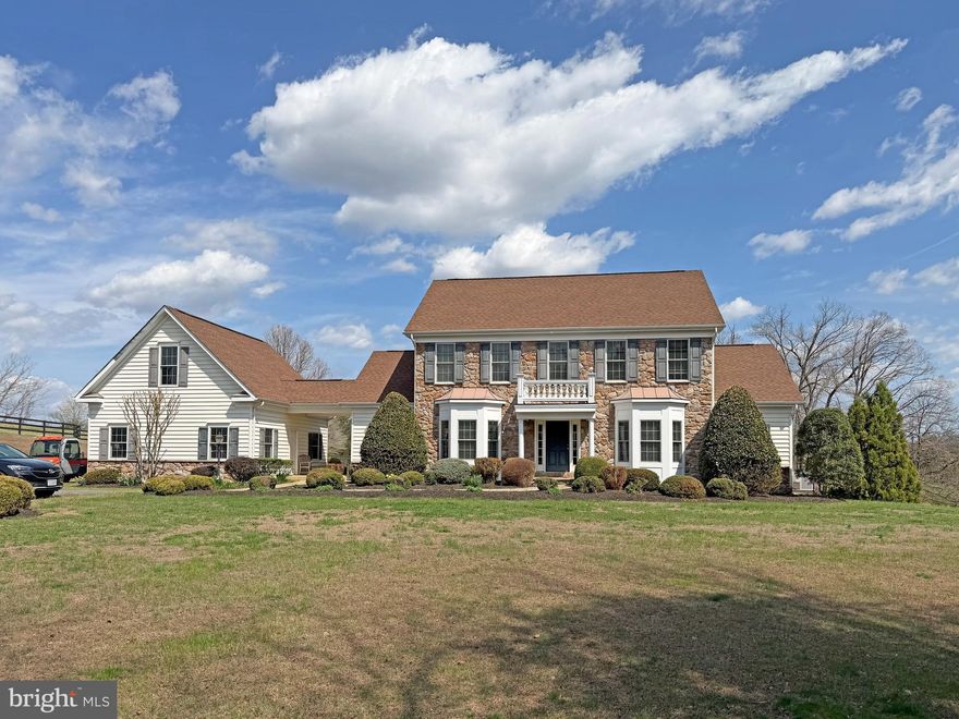 Situated on 58 acres in 5 parcels of rolling pastures and some woodland including a year-round bubbling stream this very comfortable, 4 bedroom country house can be found at the end of a very long, tree-lined drive to perfect privacy.  It features tremendous charm such as 10 foot ceilings on the first floor, many archways between rooms, abundant light throughout, and 2 large, screened porches. There is a parlor with fireplace, large dining room, family room with fireplace, a deluxe, fully equipped kitchen and a bright breakfast café that opens to a screened porch, and a half bath.  Primary suites – pick one: first floor with huge walk-in closet, private bath plus walk-in bay window; upstairs is a very large bedroom with a quiet, private nook for a desk, walk-in closet and full bath.  Also upstairs, the other bedroom has a private bath, walk-in and best of all – a large, screened porch with views of the 50 foot pool and gardens … what a way to say goodnight to a moonlit countryside or greet your morning.  On the lower level one finds a spacious recreation room with French doors to the patio and pool and a bedroom with walk-in and bath.  There is plumbing roughed-in for a kitchen.  Double garage with large storage attic.
The stable has ten stalls, 2 wash racks, 2 grooming stalls, tack room, laundry and the extra-wide center aisle.  There are five board fenced paddocks, a lunging ring and an outdoor arena 300’ by 180’ with stone dust footing.  This listing incudes Culpeper County parcels 27-61, 27-61B, 27-61A, 27-61 A1 and 27-61A2.  Property is in land use tax program.  Verify dimensions and utilities.