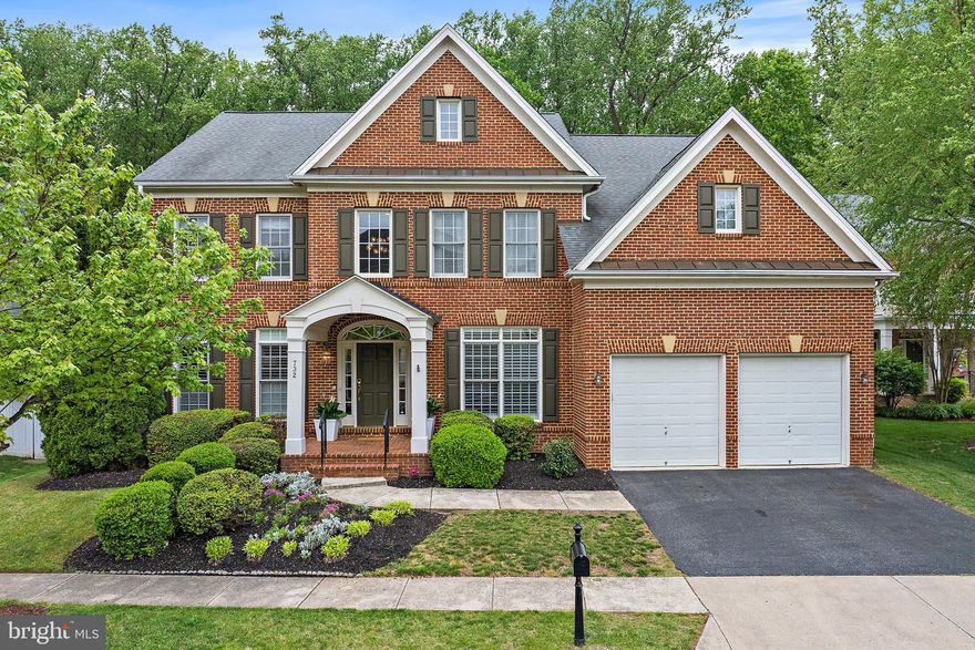 Stunning brick front colonial with over 6,000 total square feet featuring 4/5 bedrooms and 4½ baths across 3 finished levels on a premium lot. This  home offers a sunroom, an updated eat-in kitchen with a recently installed oversized white stone  island and a new refrigerator and dishwaher offering perfect space for family meals and entertaining. Enjoy a 2-story great room with a wall of windows and gas fireplace, plus a main-level office, a formal living and dining room- all with hardwood floors. The primary suite boasts hardwood floors, tray ceiling, and peaceful views of the woods. The lower level has a full bath, a recreation room, an exercise room with special rubber flooring and a potential 5th bedroom with outside entrance. The rear fenced yard backs to open space with walking paths and woods, including a patio and spacious lawn. Additional highlights include a 2-car garage with finished flooring, recent carpet and paint throughout. Located in the sought-after, community of Kingsport, offering easy access to downtown Annapolis and community routes to BWI and Washington, D.C. Community amenities include  a pool, community pier, tot lot, kayak storage, and walking paths. A perfect blend of comfort, style, and outdoor enjoyment!
