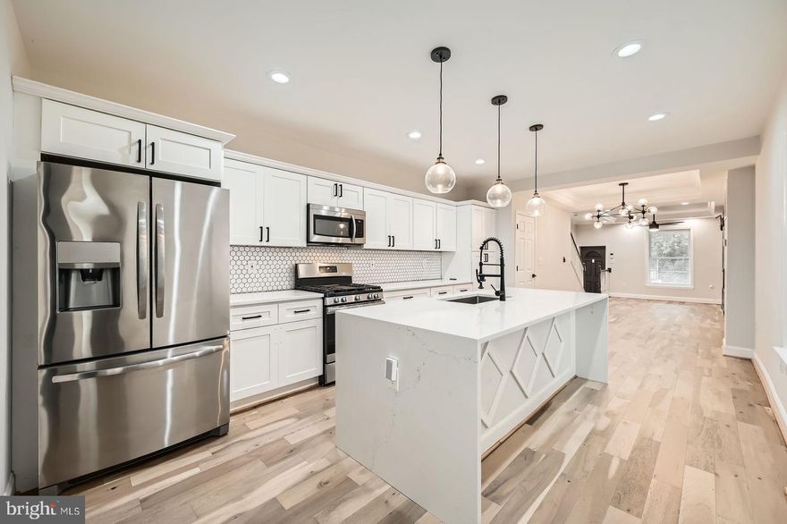 Welcome to 3014 Oakford Avenue, Baltimore, MD 21215 – Where Style Meets Opportunity!
Step into this beautifully renovated 4-bedroom, 2-bathroom home nestled in a quiet, well-established neighborhood. Offering three fully finished levels of thoughtfully designed living space, this move-in-ready gem blends classic charm with modern upgrades.  The main level features gleaming wood floors and a bright, open layout that flows seamlessly into a stunning kitchen equipped with granite countertops, stainless steel appliances, and a central island—ideal for both everyday meals and entertaining guests. Upstairs, you'll find three spacious bedrooms and a beautifully updated full bathroom designed for comfort and style.  Downstairs, the finished basement with a private entrance expands your living options with two bonus rooms, a fully renovated bathroom, a cozy lounge area, and a sleek bar—perfect for guests, hobbies, or a private retreat.  To top it off, this home offers flexible lease-to-buy terms, making it an excellent opportunity for buyers looking to transition from renting to owning with ease.  Don't miss your chance to call this beautifully updated residence your own—schedule your showing today!
