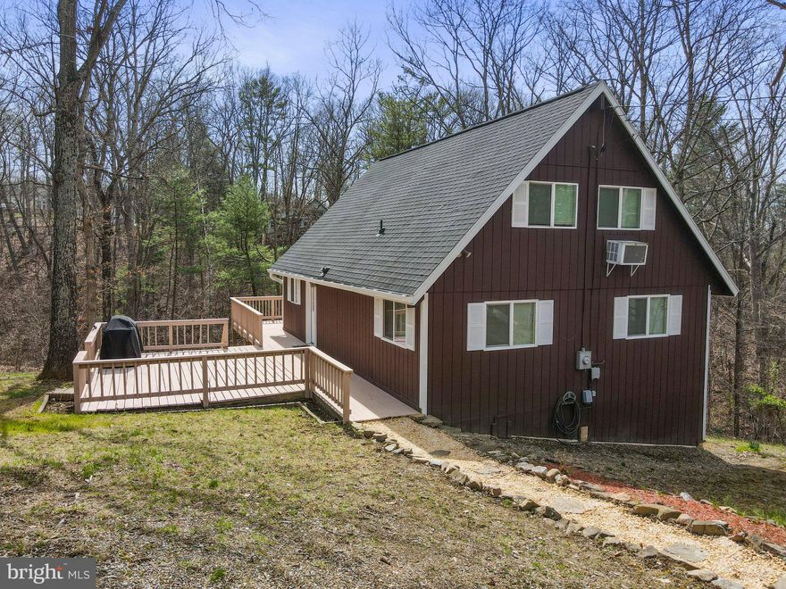 Cozy chalet in the woods on 1 acre lot with stream at the back of the property.  Main level offers 2 bedrooms, 1 full bath, kitchen and family room with woodstove.   Upper-level loft.  Recent updates include new roof, remodeled bathroom, new flooring and new water heater.   Other features include, wrap around deck, tall crawl space and storage shed.