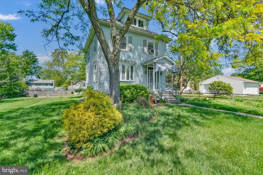 Stately Colonial home in Woodlawn Park, offering a peaceful retreat surrounded by lush perennial gardens across an expansive property. Picture hosting gatherings on the brick patio, unwinding on the covered porch, or strolling through vibrant, blooming flower beds.

Inside, you’re welcomed by a gracious foyer featuring original wood trim and a classic newel post staircase. The main level feels warm and inviting, with tall ceilings and abundant natural light throughout. Luxury vinyl plank flooring leads into the living room, complete with cherry built-ins, while the spacious dining room easily accommodates a large table and buffet, with views of the side and rear landscape.

The kitchen offers a functional layout with ample counter space, ideal for everyday cooking and entertaining. Upstairs, the primary bedroom spans the full width of the home and features carpeted floors. The second and third bedrooms showcase hardwood flooring, with the third offering access to the rear addition rooftop—an opportunity to create a future balcony. The upper-level bathroom is finished in tile and includes a shower.

From the primary bedroom, a fixed staircase leads to the attic, providing convenient storage along with a large cedar closet. The partially finished basement adds valuable living space, including a recreation room, second full bathroom, and laundry area.

Outside, the detached garage has been converted into a workshop, offering flexibility for a skilled buyer to use as-is or convert back to a traditional garage. Recent updates include an architectural shingle roof on the home and a traditional shingle roof on the garage.

The home is being sold strictly as-is, and the seller will make no repairs. The property will be listed as active prior to the consideration of any offers.
