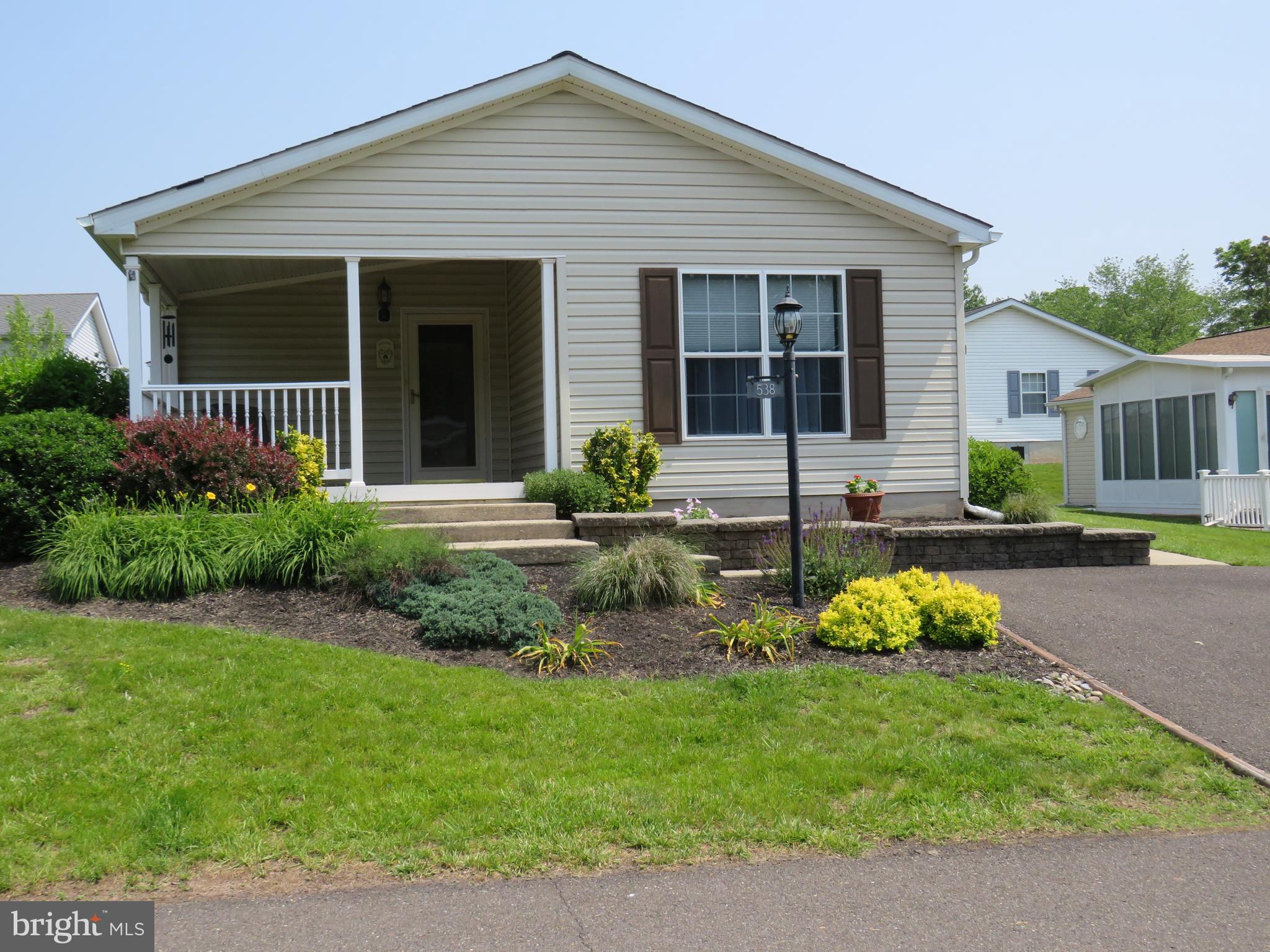 This lovely home is located in 55+ Buckingham Springs on a cul de sac street. The covered front porch is large and great for entertaining and your enjoyment. Enter into the formal living room with large double closet that opens to kitchen and formal dining room. This is a split floor plan and has a bedroom and bath at the front of the house and the primary bedroom and private bath at the back of the house. There is a family room off the formal dining room. The laundry/ utility room is off the hall and has door to outside to the side patio and shed. Quick closing possible, lot rent covers sewer, common area maintenance, clubhouse and pool.