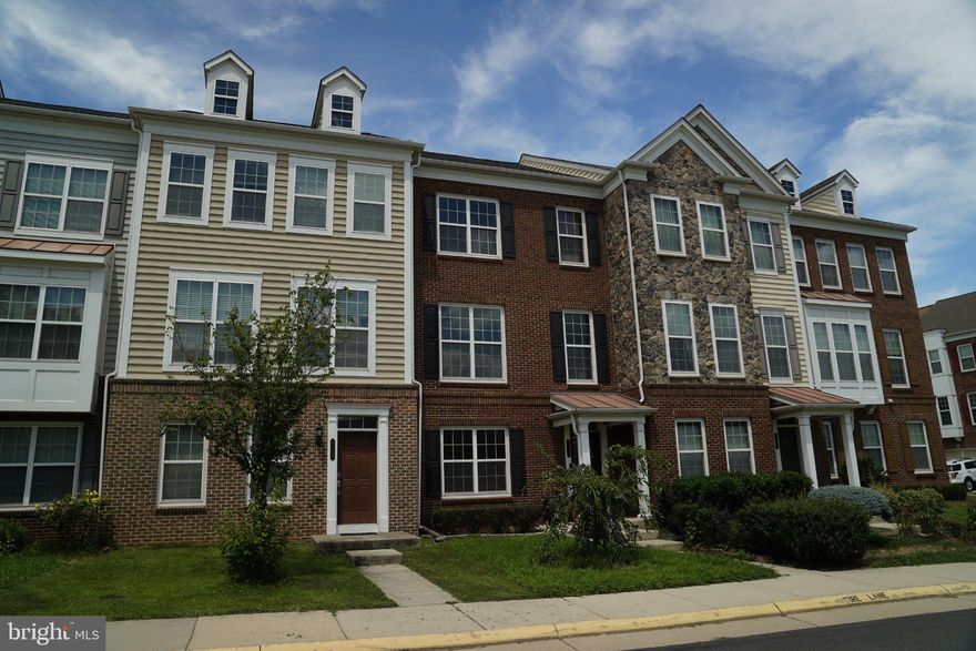 Welcome to this meticulously maintained, 3-story townhouse with a spacious 2-car garage, perfectly situated in South Riding! Enjoy unparalleled convenience, being just a minute's walk to the bus stop and East Gate Market Plaza.

This home feels truly new, boasting a new roof(2022), a freshly painted interior throughout, and crown molding. The entry level features a spacious sitting area with a convenient half bath and practical under-the-stairs storage. Newly installed hardwood stairs lead you to the main living level, which boasts hardwood floors throughout the living and dining areas, a bright, naturally lit living room, and a welcoming kitchen. The kitchen is a chef's delight, equipped with a new refrigerator and microwave (2023), plus a versatile island with a breakfast area.

The upper level, updated with new hardwood floors (2023), features a beautiful master bedroom and two additional bedrooms with a shared full bath. The master bath is a true oasis, offering a huge soaking tub, a separate shower, and a double sink.  This home seamlessly blends style, modern comfort, and prime accessibility.