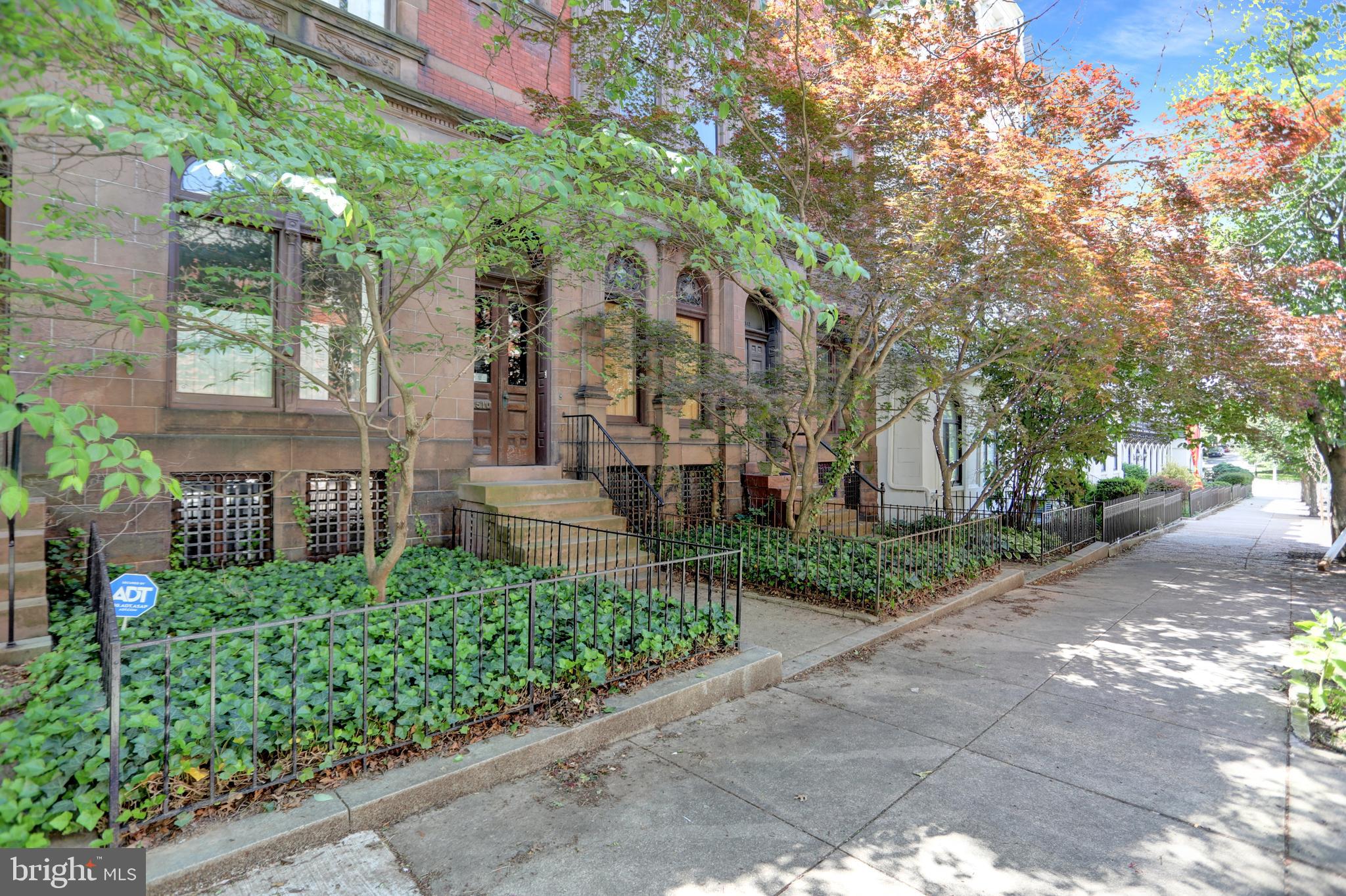 Nestled on a leafy, tree-lined block in one of Baltimore's most architecturally treasured neighborhoods, this grand Bolton Hill townhouse masterfully blends original character with thoughtful updates. Beyond the stately brownstone façade, you’re greeted by soaring ceilings, exquisite moldings, and richly preserved hardwood floors throughout.
The main level features an expansive living and dining area adorned with ornate woodwork, dazzling chandeliers, and intricate tile fireplaces—each room telling a story of 19th-century craftsmanship. The updated kitchen is both functional and stylish with custom cabinetry, a turquoise tiled backsplash, marble countertops, and a professional-grade faucet, all beneath a stunning ceiling height that amplifies the light and openness.
Retreat to the serene primary suite, complete with a spa-like bathroom showcasing a free-standing soaking tub, brass fixtures, and a striking blue-tiled walk-in shower. Generously sized bedrooms, ample closet space, and multiple fireplaces provide warmth and charm throughout the home.
Step outside to find your private sanctuary: a large deck overlooking a beautifully hardscaped brick patio and mature trees—perfect for quiet mornings or entertaining under the stars.
Whether you’re drawn to Bolton Hill’s storied past or its vibrant present, this timeless home offers the best of both worlds—historic grandeur with modern upgrades. Just minutes to MICA, Penn Station, Bolton Swim & Tennis, and all the dining and culture of Midtown Baltimore.