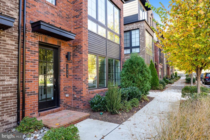 Stunning 4-level luxury townhome, with more than $150k in upgrades! With over 2,800 sq ft of living space, including 3 bedrooms, 3 full and 2 half baths, this spacious and light-filled end-unit has premium placement, inside the community rather than along the main road, with super convenient guest parking, and includes a 2-car garage, in addition to a driveway that can accommodate two cars. The entry level, with wide foyer and high ceilings, features a large bedroom, with walk-in closet and full bath. The expansive open floor plan on the main level features wide-plank flooring, 10 ft ceilings, a family room, dining area and powder room. The gourmet kitchen features stainless steel appliances, full-height (to ceiling!) cabinets, quartz countertops and backsplash and an upgraded, oversized island with additional cabinets and space for seating. The upper level has two large bedrooms with walk-in closets. The primary spa-like bathroom features a double sink vanity, stand alone soaking tub and oversized glass shower. The well-appointed laundry room is on the bedroom level with cabinets, a linen closet and vanity with sink. The top level offers a private loft with ½ bath - perfect for a guest bedroom, home office, hangout space for kids, game day viewing or exercise space - and leads to the partially covered rooftop terrace, complete with a gas hook-up and hose bib, perfect for entertaining or just enjoying the outdoors. Features to note: Wide-plank luxury vinyl flooring throughout, high ceilings, oversized windows on three sides, large balcony off family room, kohler fixtures, hardwood stairs, upgraded lighting and media package, community-maintained landscaping, a bike share station just around the corner and a playground down the block!  Less than 2 miles to Reston Town Center, and just down the road from Reston National Golf Course, Target, Whole Foods, Wegmans and Trader Joe’s. As members of the Reston Association, residents have use of swimming pools, tennis courts, other recreational areas and trails. PLUS the Wiehle-Reston East Metro station and Reston Town Center Metro station, both on the Silver Line, are less than a mile away.