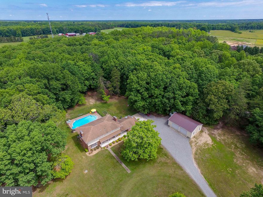 Looking for a private retreat in the country?  This is it!  This beautiful home sits on 30 private acres surrounded by mature hardwood trees.  Traditional floor plan offers high ceilings, lots of windows to let in lots of natural sunlight.  The main level has a large kitchen facing the inground pool, laundry area, half bath, family room with wood burning fireplace, wine fridge and mini fridge, separate formal dining room and living room with another wood burning fireplace and doors leading to the covered patio.  Upstairs are 3 generous sized bedrooms, full bath with double sink and the master suite which includes wood burning fireplace, private balcony overlooking the pool, private master bath and walk in closet.  Unfinished walkout basement is great for additional storage or turn into a game room.   There is a large covered front porch and a spacious breezeway between the 2 car garage and the home for grilling or gathering.  Small deck area off of the breezeway.  The 20 x 40 inground concrete pool was completely redone in 2020 and converted to saltwater for easy maintenance.  Fully fenced and stamped concrete.  The oversized detached garage/workshop has electric and plenty of room to work on projects or store farm toys.  Home is very private and surrounded by several other large tracts which allow for extreme privacy.  Just a short distance to Ladysmith, 30 minutes to Massaponax, 30 mins to Ashland and approx 40 to Richmond.