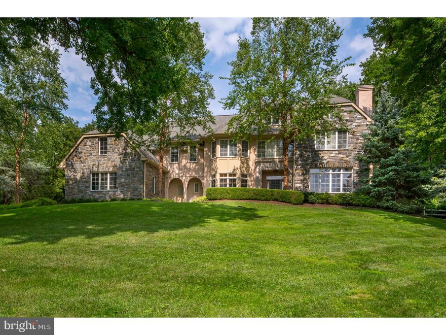 Impeccably built in 2002, this stunning Colonial draped in stone & stucco offers tremendous curb appeal, surrounded by lush greenery & beautiful mature trees on an acre of grounds. A long drive leads up to a generous 3-car built-in garage that conveniently accesses the home, located in a prime neighborhood near top-rated Lower Merion schools & all conveniences!   Guests will arrive at the main front door where they're received by a gracious open foyer featuring a grand center hall staircase. Large openings spill into the elegant main rooms, all with hardwood floors, for easy entertaining. Relax around the fire in the spacious living room with light-filled windows on 2 exposures showcasing lovely views. On the opposite side of the reception area is a generously-sized dining room for formal meals brightened by a wall of front-facing windows. Serving the dining room & connecting the gourmet kitchen is a pantry area with wood cabinetry & granite counter. What a dream kitchen for the chef, styled with griddle maple cabinetry, black granite countertops, tumbled marble tile backsplashes & Jenn-Air stainless steel appliances. The huge angled island offers plenty of room for prepping & family seating, with lots of storage too! Enjoy breakfast overlooking the scenic property in the open morning room, sun-bathed by triple walls of windows with glass doors to outside. As phenomenal is the open family room, divided from the kitchen by columns, with cross-beamed ceilings, a stone fireplace, stretching window walls & glass doors to the rear patio. Also on the first level is a charming powder room & peaceful office with French doors, built-in bookcases & picture windows.   The 2nd-floor hardwood landing greets you with an oversized window at the top of the stairs & leads to 5 bedrooms (2 en-suite), a sitting room & hall bath. The sprawling master bedroom presents a sitting room & gigantic bath with separate his/her vanities, a walk-in shower, toilet room & spa-like soaking tub. The nicely-finished lower level with recessed lighting offers flexible space for recreation, a home office, a media lounge, game room & much more. Entertain in outdoor bliss on the paver-stone patio with a pergola, multiple sitting & dining areas, a raised garden area & endless lawn for the all to play.