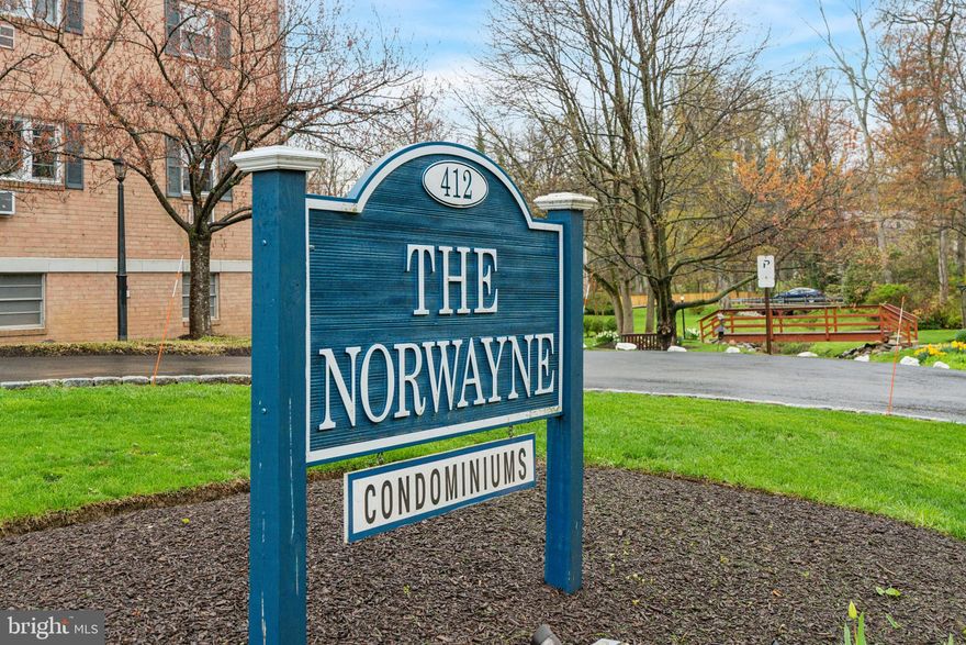 Welcome to Unit 108 at The Norwayne — an elegantly maintained 2-bedroom, 2-bath condominium offering the best of low-maintenance living just steps from the heart of downtown Wayne. This first-floor home provides 1,130 square feet of comfortable, light-filled space, highlighted by a spacious living room with sliding glass doors that open to a private patio — perfect for morning coffee, container gardening, or quick access to the parking area. A well-proportioned dining area flows seamlessly into the galley kitchen, featuring warm wood cabinetry, tile flooring, and ample prep space for everyday meals or casual entertaining. The primary suite is a true retreat with multiple windows, double closets, and a private en-suite bath. A second bedroom offers flexibility for guests, a home office, or both, with an adjacent full bath just down the hall. Additional highlights include original parquet hardwood floors, an oversized storage unit, and a dedicated underground garage parking space available for purchase at $15,000 — separately deeded for long-term value. Located within The Norwayne, a well-established and professionally managed community with manicured grounds and a charming pedestrian bridge, this home offers rare walkability in a Main Line location — just minutes to restaurants, boutiques, the R5 train, and the Saturday farmers market. Whether you're downsizing, rightsizing, or planting roots, this move-in-ready unit offers a blend of convenience, comfort, and charm in one of the Main Line’s most sought-after neighborhoods.