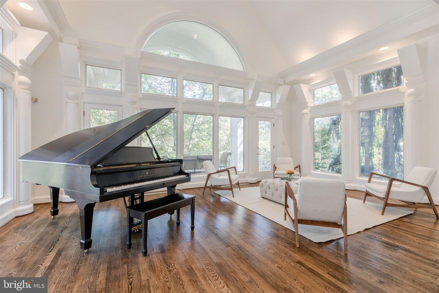 Striking custom contemporary beautifully sited high on a knoll overlooking Pimmit Run.  Built as a showcase for a prominent local architect, this residence boasts a sun-filled interior, incredible architectural details, one-of-a-kind views and over 8,000 sq ft of finished space.  The stunning great room includes a unique curved wall with fireplace, dramatic walls of windows and doors which open to a large balcony overlooking the woods and stream.  The dining space is surrounded by windows and enveloped in light.  The chef's kitchen opens to the breakfast area and family room with fireplace and two-story windows.  A spacious private office located off the paneled library has custom built-ins and a curved wall of windows.  The master suite encompasses the entire top level and includes sitting room with bathroom and dressing area with abundant closet space and spa-like second bath with soaking tub.  Located just one stop-light to DC and just minutes to Tysons this home offers a relaxing and serene retreat in the heart of it all.