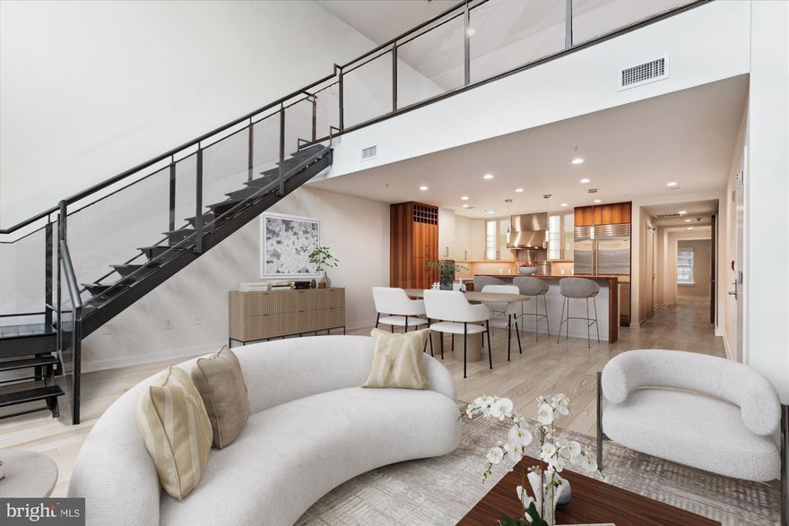 GREAT NEW PRICE for this fabulous, rarely available penthouse at Gaslight Square where only two other penthouses have hit the market in the last two years! Spanning 2,000 square feet across two floors, this luxurious residence blends the hipness of a warehouse loft with sophisticated appointments. The penthouse features two bedrooms, two-and-a-half baths, and a grand great room with a 19-foot ceiling, gas fireplace, wall of windows, and a loft. Hardwood floors extend throughout the home, which also boasts a private outdoor terrace with stunning skyline views. The open, gourmet kitchen is equipped with an oversized island, a six-burner Wolf gas stove, a Subzero refrigerator/freezer, and ample cabinet and counter space. The primary bedroom is located on the main living level, while both bedrooms include ensuite baths and professionally designed closet systems in their walk-ins. The loft and main living room offer smart storage solutions, and motorized blinds are installed throughout the home. This unit also conveys with two reserved, assigned garage parking spaces plus a private storage room (or 3rd parking space). For ultimate convenience, direct elevator access from the parking garage delivers you right into your home, making trips with luggage and groceries effortless. Gaslight Square is a boutique condominium development known for its privacy and exclusivity, ideally situated amidst the businesses, restaurants, grocery stores, gyms, and amenities of Arlington's thriving Courthouse and Rosslyn neighborhoods. Residents enjoy walking distance to two Metro stations and Georgetown, as well as a short commute to other points in the District, Tysons Corner, Alexandria, and the area's two major airports. Originally built in 2013, Gaslight Square was designed as an ultra-luxe, minimalist condo community, featuring steel and concrete construction for superior quiet and privacy. This pet-friendly community is professionally managed, with impeccably maintained and landscaped grounds. *Contact listing agents for more information or to schedule a private showing. **Lead photos are virtually staged to show interior design ideas, including refinished or lighter wood flooring.**