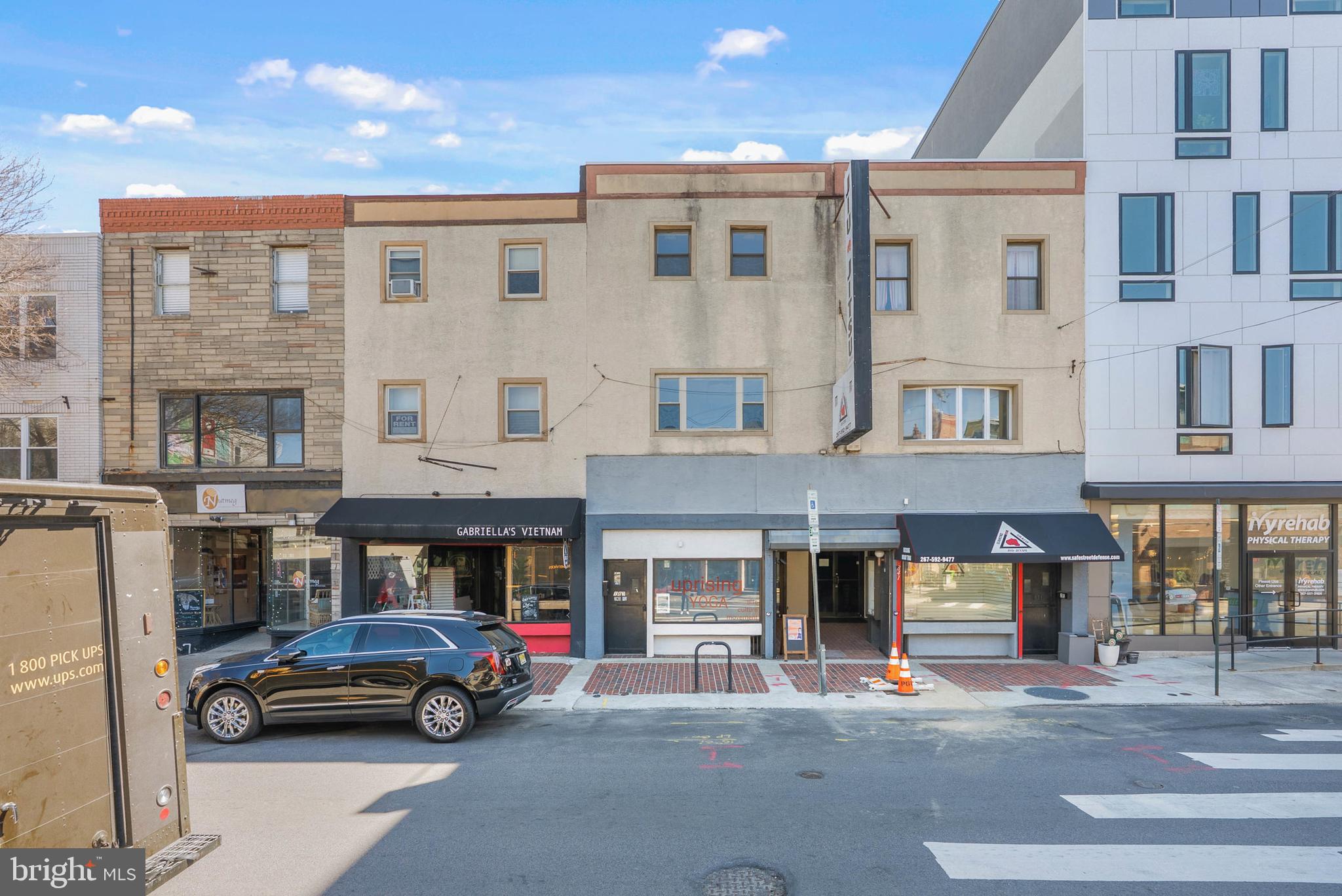 Located just off Broad St in the heart of Philly's vibrant East Passyunk neighborhood, this 3-story, mixed-use property includes a commercial unit on the first floor and second-floor rear, plus a bi-level updated 2 bed, 2 bath apartment on the upper floors. The commercial unit is currently leased on a net basis as a yoga studio and offers a reception area, open studio areas, and two restrooms on the first floor. There is also studio space on the second floor at the rear which offers the potential for conversion to an additional apartment unit. A separate door by the front entrance leads to a staircase and the bi-level apartment above. The unit has newer carpeting and laminate floors, fresh paint throughout, a large living room, a modern kitchen with a dishwasher, in-unit laundry, spacious bedrooms, and two full bathrooms. The units also have gas forced-air heat and central air. 1839 E Passyunk Ave is surrounded by top-rated restaurants, coffee shops, and entertainment, earning it a near-perfect walk score of 98! Sprawling parks and friendly neighbors create a welcoming feel for both visitors and residents. A few blocks away, the Bok Building acts as a community hub with a mix of local businesses, plus Constitution Health Plaza has various medical offices around the corner. There's also easy access to public transit, the sports complex, I-76, I-95, and South Jersey. Schedule your tour today!"