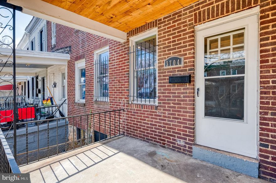 Newly Updated & Move-In Ready! This 3-bedroom, 1.5-bath rowhome in Baltimore’s Central Park Heights community combines modern upgrades with a smart, functional layout. A welcoming covered front porch and fenced yard set the tone. Inside, the main level features new laminate flooring, recessed lighting, a ceiling fan, and a sleek wall-mounted electric fireplace for added style. The open-concept kitchen shines with butcher block countertops, white cabinetry, stainless steel appliances, a tile backsplash, and a peninsula with pendant lights and breakfast bar seating—perfect for both casual meals and entertaining. A convenient main-level powder room completes the space. Upstairs, a skylight fills the hallway with natural light. All three bedrooms include laminate flooring, ceiling fans, and a fresh, neutral palette. The full bath has been completely renovated with marble-style tile, modern fixtures, and an updated vanity with sconce lighting. The finished lower level provides versatile flex space for a family room, home office, or gym, plus laundry, utilities, and walkout access. Outdoors, enjoy a fenced backyard, rear patio, and private off-street parking with alley access, along with additional front street parking. With fresh updates and everyday comfort, this home is a standout opportunity in a well-established neighborhood.