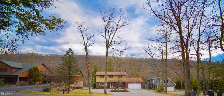 Lakefront classic with a modern sensibility! From the circular driveway, this thoughtfully updated home is a striking picture set against the backdrop of pristine Lake Hauto. As you enter the house into a gleaming foyer, you're delighted in several directions. To the left, an open-concept living/dining room is flanked to the front and back by large bow windows, offering both ample light and stunning lake views. The openness continues effortlessly into the kitchen, which also connects to the light of the living room via passthrough. The kitchen is lovingly updated with new stainless appliances, granite countertops, central island, and ceramic tile backsplash; its overall effect is taken to new heights with a pan ceiling above the island, adding another stunning detail to this home. A 250 square foot family room offers powder room, wood-burning fireplace, and access to a large, covered rear Trex deck via sliding glass doors. The main level is completed with a mud/laundry room, boasting a wall of cabinets, stainless sink in granite counter, and more stunning lake views. The garage is over 400 square feet of insulated, finished space with an ample storage closet and access to an attic above. The second level features an open hall with storage closet giving way to four large bedrooms and a beautiful hall bath, with stunning tile work throughout, including a full ceramic surround above the new cast iron bathtub. The master offers a beautifully renovated en suite with more custom tile work. The remaining bedrooms: large and bright with ample closet space. And then, a natural haven: a yard dotted with mature oaks, gently sloping to the water's edge and your own private dock, just right to hop on your boat or in the water for an afternoon swim. Lakefront living at its most idyllic.  Beyond the home, the private community of Lake Hauto offers many amenities for anglers, tennis players, avid readers, fitness fanatics, and music lovers as well as welcoming all manner of boating from kayaks to power boats!