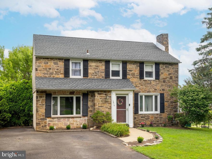 Welcome to 1814 Edge Hill Road, a beautifully maintained 3 bedroom, 2 bath stone Colonial located in the sought-after Overlook Hills neighborhood of Abington. Ideally situated just steps from the newly renovated Roychester Park, this home offers a perfect blend of classic character and modern updates. Step inside to a bright and inviting living room, complete with a gas fireplace and newer flooring. Large windows fill the space with natural light, creating a warm and welcoming atmosphere. The adjacent dining room opens to a charming side porch with park views—perfect for morning coffee or evening relaxation. The eat-in kitchen boasts a breakfast bar, laundry area, and sliding glass doors that lead to a spacious deck overlooking the beautiful backyard. A cozy family room just off the kitchen offers additional space for gathering and entertaining. Upstairs, the primary suite includes two closets and an en suite bathroom. Two more generously sized bedrooms, each with ample closet space and ceiling fans, along with a full hall bathroom and linen closet complete the second floor. The full walkout basement offers excellent potential for finishing into additional living space. Outside, the fenced in backyard is ideal for outdoor entertaining and play. Other highlights include newer systems and a prime location close to highly rated Overlook Elementary School, major highways, parks, shopping, and dining. Don’t miss your chance to own this light-filled, move-in ready home in one of Abington’s most desirable neighborhoods!