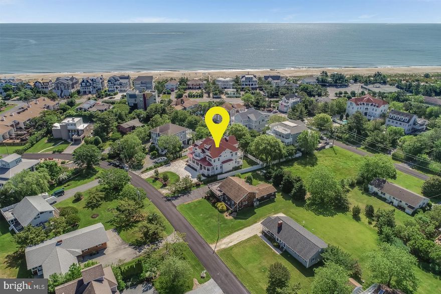 Welcome to 28 Harbor Road in the sought-after amenity rich community of North Shores. This exquisite home is truly one-of-a-kind. The circular clamshell driveway, landscaping and large front porch will give you a warm welcome as you approach this beautiful home where coastal elegance is defined. From the moment you step across the threshold, the vivacious colors used as accents throughout are sure to grab your attention! In addition, you are greeted with soaring ceilings, floor to ceiling windows, glistening hardwoods with in-laid detail and intricately designed chandeliers. Adjacent to the foyer, an elegant formal dining area offers the ideal setting for year-round entertaining. From there, you'll enter into a comfortable great room with a wood burning fireplace that is open to a stunning gourmet kitchen designed with the inner chef in mind. Those passionate for cooking and entertaining will swoon over this space complete with classic Silestone counters, a tremendous island, dual dishwashers, ice maker, beverage fridge, stainless GE Monogram fridge, GE Monogram 6 burner gas cooktop, dual wall ovens, prep sink, ample storage and large pantry with an additional full-size refrigerator. The first level also features 2 bedrooms each with en-suite baths, 2 powder rooms and a large laundry with custom built-ins creating the ideal drop zone for all of your beach gear. The second level boasts 3 additional guest bedrooms each with en-suite baths and an elegant master suite featuring a vaulted ceiling, stunning walk-in closets, a private laundry, balcony with marina views and a chic master bath complete with a soaking tub and intricately tiled walk-in shower. This level also includes a sunny nook, ideal for relaxing and a cozy rec room with a built-in window seat. On the third level you will find a well-equipped wet bar that opens to a large roof top deck with a built-in gas grill that features ocean views to the east and sunset views to the west. Other outdoor living spaces include a welcoming front porch, rear screened porch with fireplace and multiple sun decks, which are sure to leave an impression. North Shores offers a prime location to the Gordon's Pond bike trail and state park, downtown's renown boardwalk, 5-star rated restaurants, unique shops and boutiques. This community leaves little to be desired complete with a marina, swimming pool, tennis courts, security and most importantly a sprawling private beach!