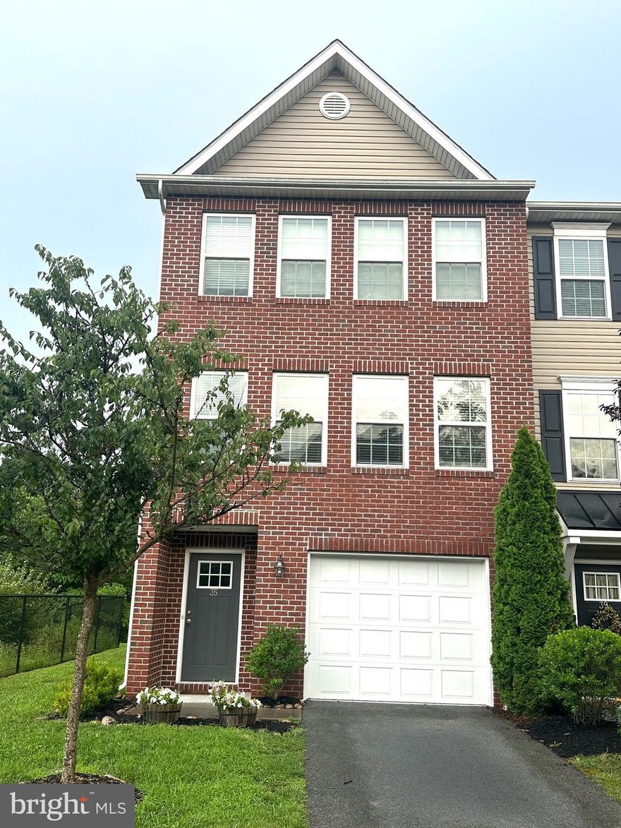 Welcome to Brookfield on the Potomac, a sought-after community offering private river access, a boat ramp, and a picnic area. This pristine Panhandle Builders three-story brick end-unit townhome features a one-car garage, a private backyard, and an inviting 16 x 8 deck. The open main level presents a kitchen with a center island, pendant and recessed lighting, stainless steel appliances, and abundant cabinetry, perfect for entertaining with direct deck access. A light-filled family room with new carpet and a half bath completes this floor. Upstairs, three bedrooms include a primary suite with a walk-in closet, dual sinks, and a walk-in shower. The finished basement offers versatile space for a fourth bedroom, gym, or extra living area, plus a half bathroom and backyard walk-out. Located on Savage Ct, a charming cul-de-sac, this home provides excellent commuter access to I-70 and I-81.