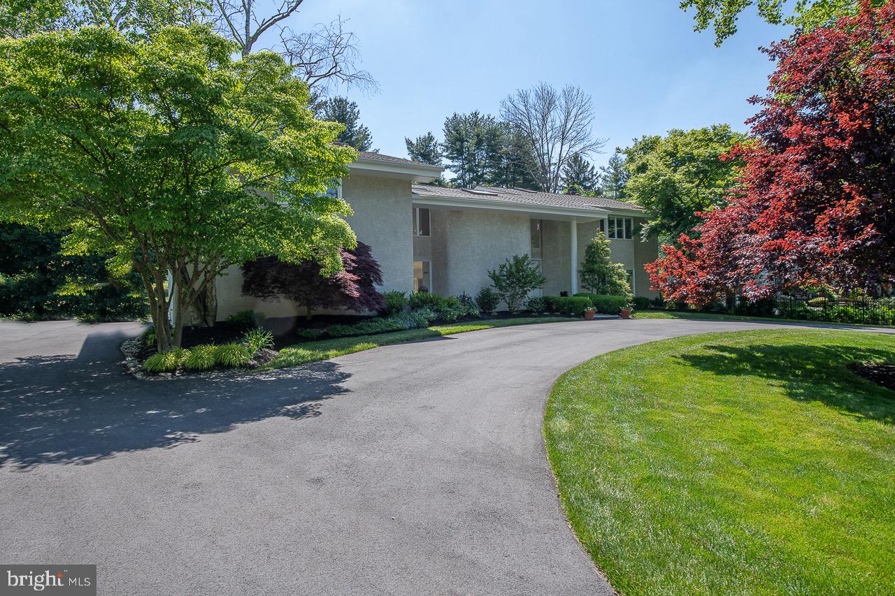 Modern, bright Contemporary home in sought after Gladwyne. Entering this well maintained custom home, you are greeted by a vast open floor plan abundant with natural light. The spacious first floor includes a large living and dining room with wood burning fireplace, modern kitchen with custom cabinetry, stainless steel appliances and granite counter tops, an ample family room with built-ins, fireplace, and sliders to the backyard and a large bedroom / office with closets and new Porcelanosa bathroom. In every direction of the first floor there are views of the surrounding foliage and greenary due to the open floor plan. Along the entire back wall of the house, glass sliders lead to a sizable deck and beautiful backyard, perfect for entertaining and family holidays. The second floor of the home features a substantial master suite complete with sitting area, fire place, balcony overlooking the backyard, dressing area, and bathroom complete with new spa shower and tub area. There are three additional large bedrooms on this level, with two new Porcelanosa bathrooms, laundry, and rear stairs to the family room. The lower level offers a finished game room and an area for a gym with brand new wood style flooring. The garage is built for four cars and has inside access. The grounds have been meticulously landscaped and maintained. Close to #76, Blue route, shopping, schools, parks and Philadelphia Country Club!!