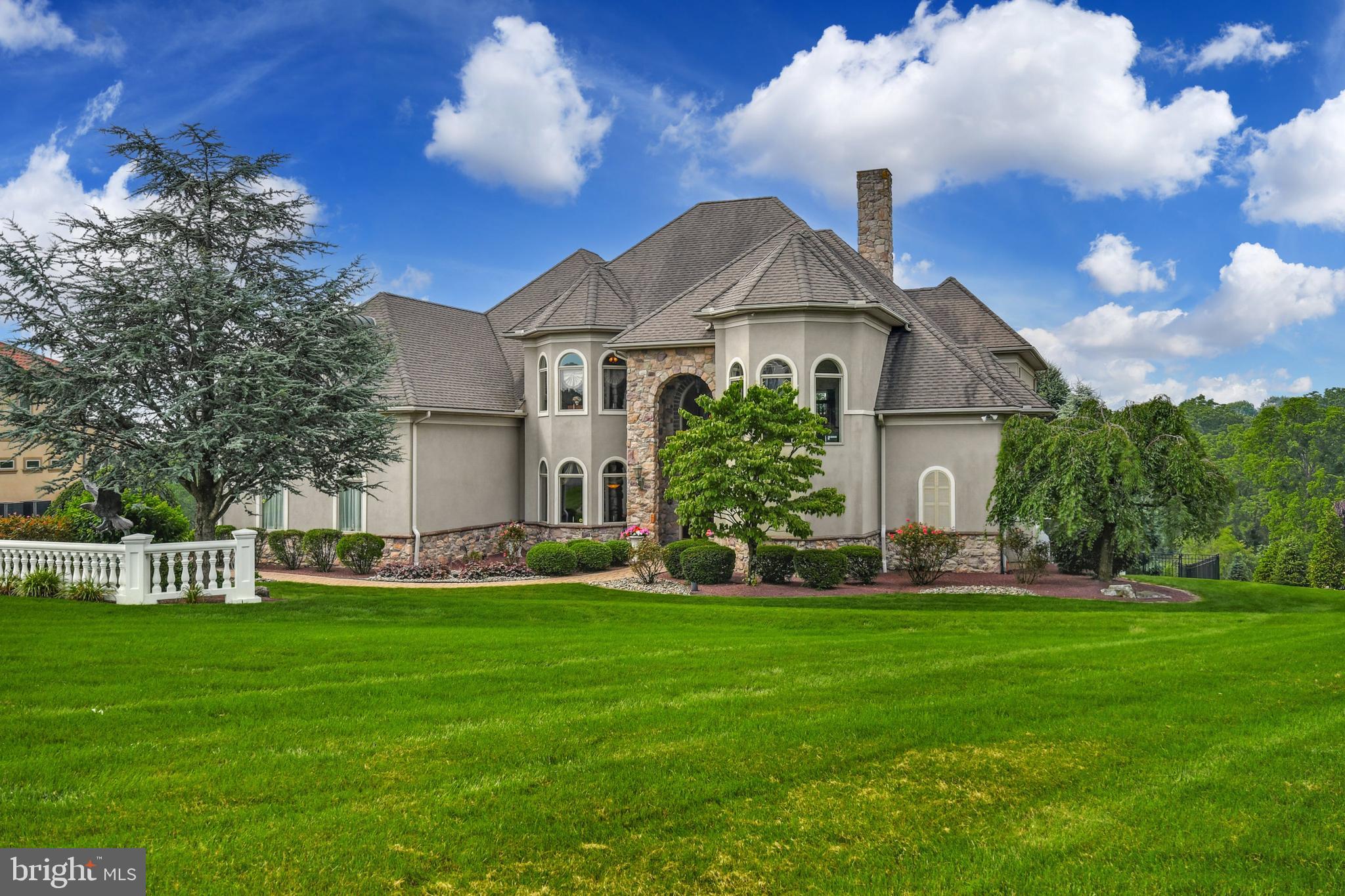 This stunning home, prominently positioned on 1.248 acres in the desirable neighborhood of Valley Road Estates in Orefield, has breathtaking, long-distance views in every direction. Close proximity to commuter routes, hospitals, shopping, dining and entertainment venues makes this an ideal location for a variety of lifestyles.
The remarkable 6,900+ square foot home has been beautifully designed, with magazine-ready details and impeccable taste. Gleaming Brazilian cherry floors and radiant heated tile bring both physical and visual warmth to rooms that are accented with soaring ceilings and abundant windows. A grand foyer with an elegantly curved staircase opens to dining and living rooms, with crown moldings, arched transoms and a gas fireplace. The gourmet kitchen is the heart of the home, with cherry cabinets, granite countertops and top-of-the-line stainless appliances. A walk-in pantry and sunny breakfast area open to the family room with a marble fireplace and built-in bookshelves.
A striking first floor primary suite with sitting area features an en suite bath with dual sinks and mahogany cabinets. The upper level includes two large suites, a guest bedroom and two additional rooms which can be repurposed as flexible space for exercise or game rooms. The finished walkout lower level has radiant heated floors and flexible rooms for storage, hobbies or entertaining, as well as a theater room. Enviable outside spaces feature a heated inground pool and paver patio, with a Trex deck overlooking it all accessible from multiple interior rooms with spiral stairs to the yard.