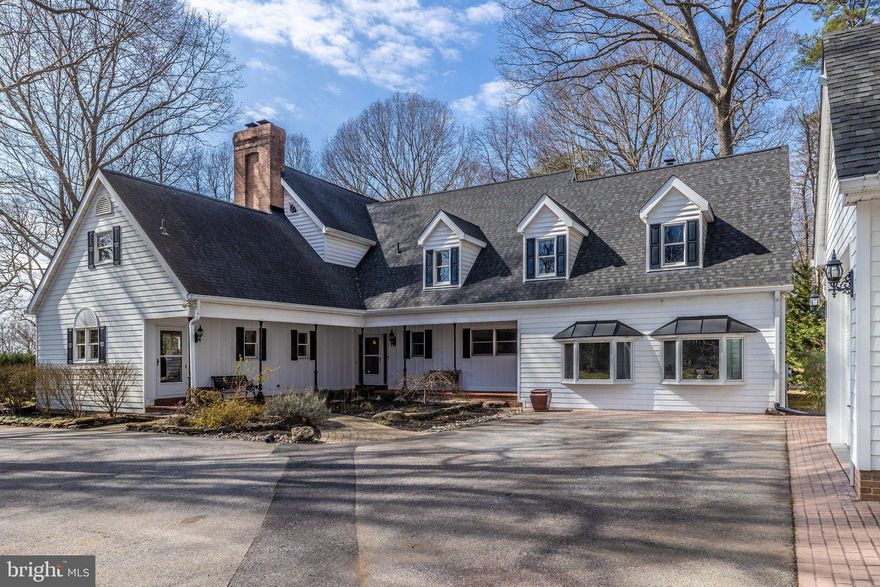 Welcome home! The sunrises are amazing and the sunsets are inspirational in this five bedroom, architect-designed - nearly 4,500 square foot, two-level colonial that sits nestled in privacy along Lyons Creek and the Patuxent River amid 5.8 acres of woodlands and waterfront. Includes a private pier/dock with a boat lift as well as community boat dock. Massive kitchen and living room with multiple attached porches and patios are perfect for entertaining.  Three  of the Five  bedrooms (including the large downstairs owners’ suite & 2 west-facing bedrooms upstairs),  have open views of Lyons Creek and the Patuxent River.  Check out the upper and lower verandahs perfect for contemplative morning coffee times or evening reading with a glass of award wining wine. 
The  upstairs bedrooms each come with walk-in closets,  private entries to the covered verandah, and a jack-and-jill bathroom. The third upstairs bedroom is east-facing and spacious with an extra large walk-in closet, and an even larger adjacent unfinished attic space that has many potential uses. The downstairs guest bedroom is east-facing and adjacent to a large, well-lit rec room with wood-burning stove and private entry. It also has direct access to a full-size bathroom with a jacuzzi tub. This guest bedroom can alternatively be used as a downstairs private office. 
The modern kitchen is well-equipped with spacious granite countertops, a 6-burner Viking gas stovetop, Wolf multi-function full-size oven, built-in CAFÉ Advantium microwave & convection oven, Kenmore dishwasher, abundant oak cabinetry and floors throughout, built-in kitchen desk, and a large refrigerator that blends seamlessly with the wooden cabinetry. The house is designed with  gatherings  in mind, and the open-plan, eat-in-kitchen, and adjacent living area share an awesome 2-sided fireplace (originally woodburning, converted to gas). The downstairs owners’ suite includes a large  bedroom, two walk-in closets, and an adjacent bathroom suite with heated stone tile floors, a soaking tub with waterfront views, a stone tile shower, individual his and her sinks, and a privacy closet with toilet and a separate sink. 
An additional ‘hobby room’ provides a 2nd refrigerator and additional cabinets and countertop spaces, as well as a built-in ironing board, for crafting and storage. This room adjoins the spacious laundry room next door which has additional storage cabinets. Beyond the laundry room, there is an additional climate-controlled storage room for cleaning and maintenance supplies.
 For vehicles and additional storage, there is a detached 3-car garage with an open upstairs loft space. The garage includes an attached fully-enclosed garden shed on one side, and an attached carport on the other. The Patuxent Palisades neighborhood is a highly desirable community.  The  neighborhood amenities include a shared park with  pond, paved walking trail, play equipment, and tables and chairs for picnicking; a boat dock on the Patuxent River; and seasonal community activities. 
 Experience and view the wonder of  nature  with bird-watching, boating, kayaking, canoeing, paddleboarding, water-skiing, hiking, camping, and fishing available right in your backyard. This easy to maintain 5.8 acre lot offers plenty of room for exploring.  The Chesapeake Bay is less than 15 miles to the east, and Washington DC is only 30 miles to the northwest. For the everyday necessities,  Dunkirk Town Center, with  three grocery stores and all the other services, is just minutes away .  Schools are close by as well. Check out the community park. Community has a gated private dock access for larger boats.
Call your Realtor and come see this unique and delightful property.