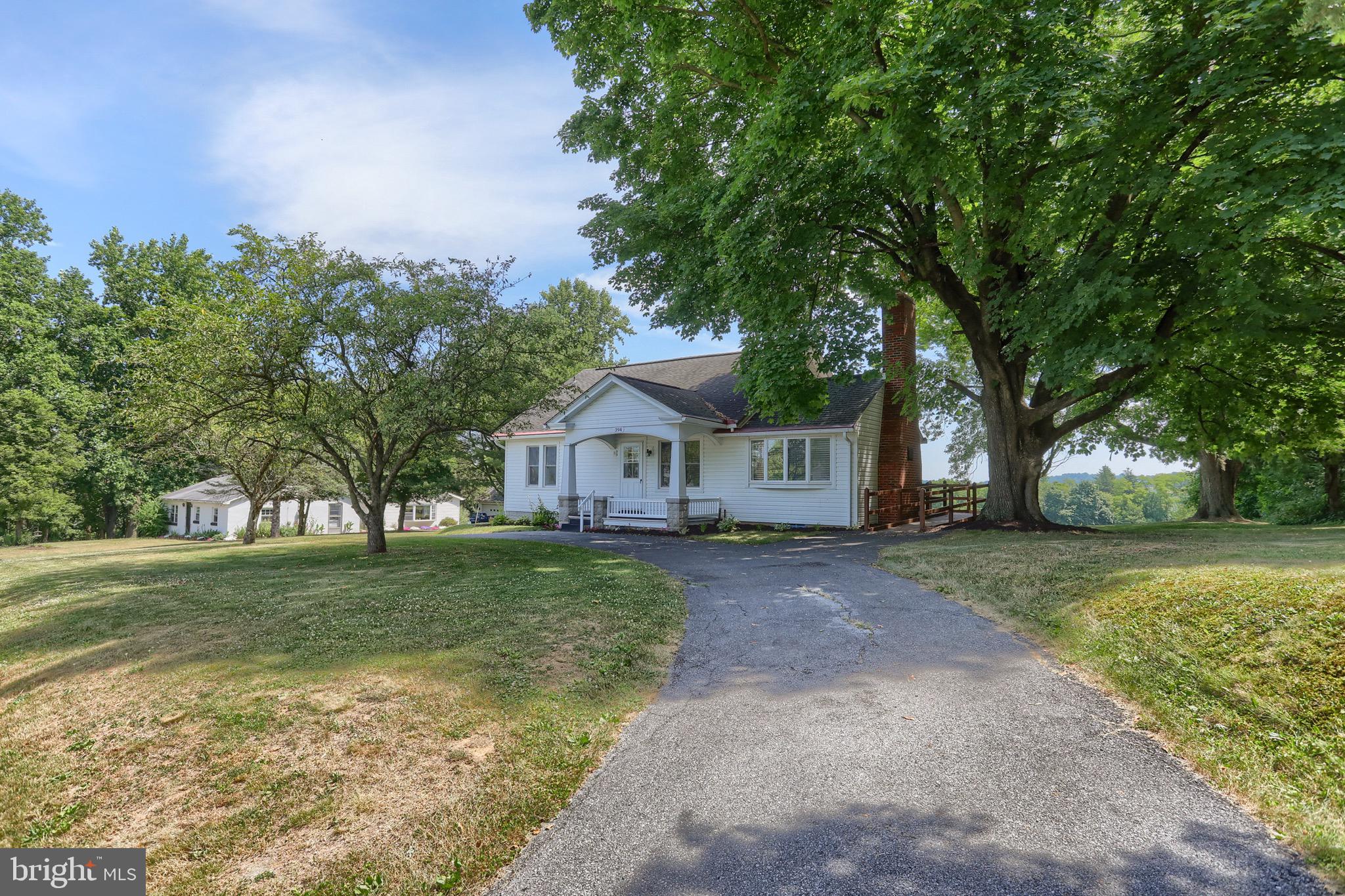 Where will you want to enjoy your coffee? The front porch or the rear covered 21x14 patio. Both will not disappoint! As you pull into the circular driveway, you will be greeted by this cozy cape-cod-style home with fresh landscaping. There is also an extended driveway to the rear of the home/garage area. Step into the spacious living room with a wood-burning fireplace. Off of the living room is a separate dining room with a great view of the rear yard and sliding glass doors leading you to the rear patio. The kitchen is equipped with stainless steel appliances, tile backsplash, a pantry, an eat-in area, and a sliding glass door with that same great view and access to the rear patio.  Laundry hook-up is currently located in the kitchen area but could be relocated back to the lower level.  Because you could put a coffee bar/beverage center in its place.  2 bedrooms and a full bath are located on the main floor. The 3rd bedroom and a spacious separate bonus room. are located on the 2nd floor.   Which could be used as a 4th bedroom, WIC, storage, game room, or whatever your heart desires. There is a handicap-accessible ramp with access into the living room. Central air to keep you cool during a heat wave.  This home has been well cared for.  Let's not forget to mention this home sits on a .77-acre lot. The only thing you need to do is schedule a showing and come and check it out for yourself!