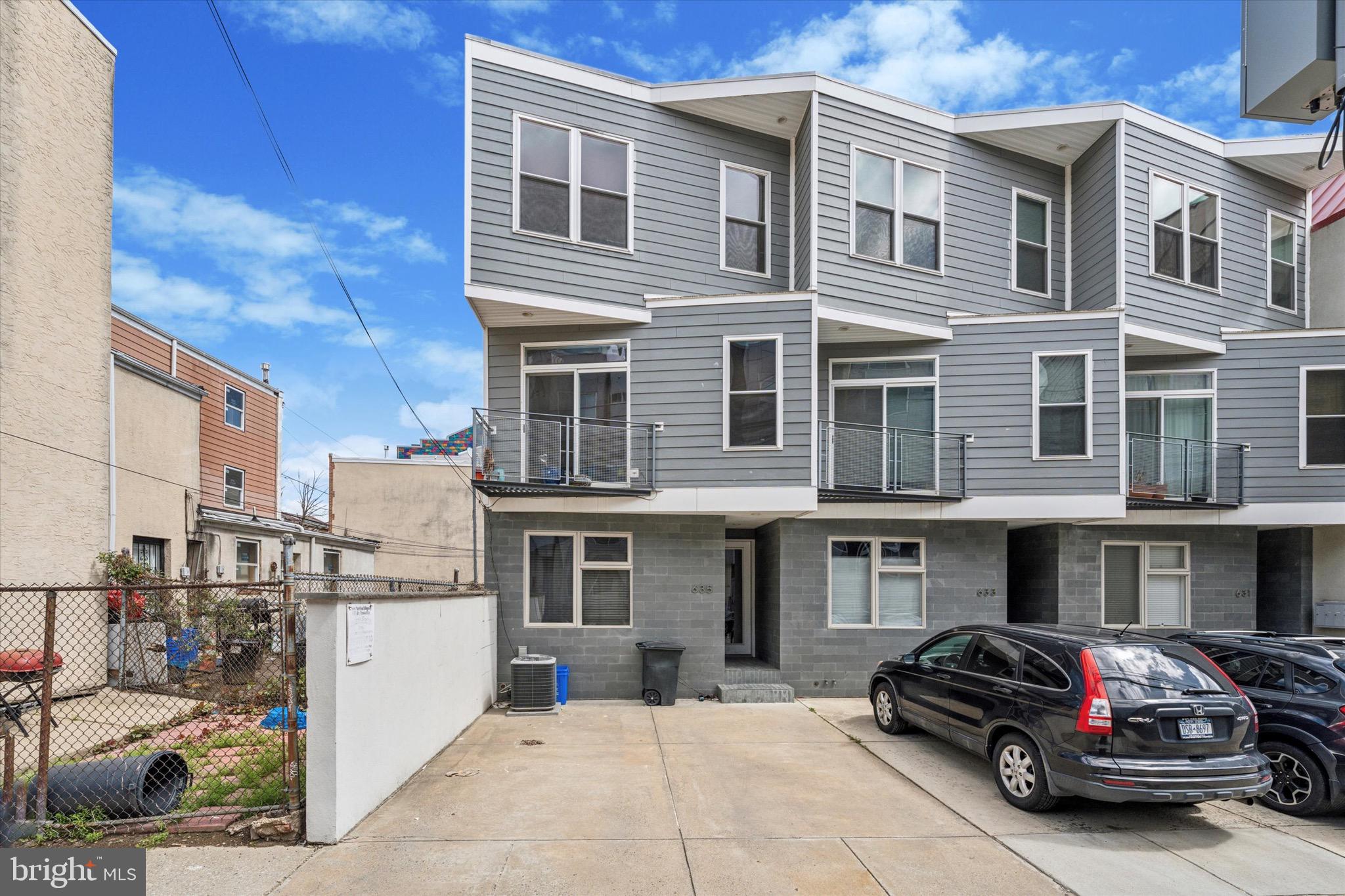 635 North 13th Street, Unit A is a contemporary townhome located in Philadelphia’s West Poplar neighborhood, within walking distance of Spring Garden and Fairmount, and sharing the zip code with Northern Liberties. This spacious home features two large bedrooms with the potential for a third in the finished basement, three full bathrooms, and one half bath. With approximately 2,183 square feet of living space, the home offers a recently updated kitchen outfitted with sleek quartz countertops, white shaker cabinetry, stainless steel appliances, and abundant natural and recessed lighting. The first-floor family room is highlighted by nearly floor-to-ceiling windows that allow natural light to flood the space. The primary suite, located on the second floor, includes large windows, recessed lighting, hardwood floors, and an en-suite bathroom adorned with travertine tile. The finished basement offers an expansive 800-square-foot family room with travertine flooring, making it ideal as a third bedroom. It also features a luxurious bathroom with black marble subway tile and a soaker bathtub, creating a spa-like retreat. A private patio off the back of the home is perfect for family gatherings, and off-street parking adds convenience to this thoughtfully designed home. Combining modern elegance with functional design, this property is ideal for those seeking a dynamic urban lifestyle in Philadelphia.