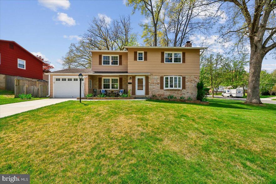777 Kimberly Court E is the epitome of the suburban dream: a beautiful, brick-front 4 bed, 3.5 bath Colonial, set on a huge corner lot with fully fenced backyard, one car garage, finished basement, and meticulously maintained with updates throughout the space! As you enter the home, notice the flagstone paved walkway and covered sitting area tucked into the front of the house behind the raised garden beds. Through the entryway, you’ll find beautifully refinished hardwood floors, and a light-filled living room, dining room, kitchen, den, powder room and plenty of closet space. The sellers renovated to open the space between the kitchen and dining room and added a huge bay window to create an airy, light space which looks out on the sizeable grassy lot. Upstairs, you’ll find more refinished hardwood floors, plus 4 bedrooms, including the primary with an en suite, and a full hallway bathroom, and more closet upgrades! The lower level is a finished, carpeted space with fireplace and stone hearth, another full bath, massive laundry room and storage space. Outside, a  one-car garage has two additional doors for use, making it versatile and accessible, whether you are strolling out to your large front yard, or entering the fully fenced, flat and grassy backyard with patio, mature landscaping and built-in storage closet. Meticulously maintained with tons of smart updates throughout the years, this property has it all: natural light, elegant storage solutions, and a gorgeous yard, on wide, tree-lined streets in a location you can’t beat! Less than a mile from the Kentlands and close by to other retail, restaurants, and entertainment like Rio Lakefront, Crown, Seneca Creek State Park, plus commuter access to I-270, this spot is also just around the corner from the skate park, sought-after schools, and businesses. Come and see what suburban perfection looks like! It could be yours!