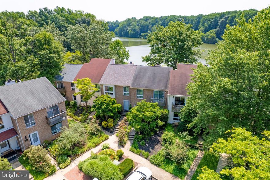 Lovely Columbia lakefront residence within footsteps of Lake Elkhorn. Beautifully updated three level 2,100+ SF townhome greets you with a landscaped front yard,  bright foyer, hardwood floors and open flowing floor plan.  Spacious dining room area and fully equipped kitchen with solid maple cabinets, black granite tops, subway backsplash, under cabinet lighting and stainless steel appliances. Continue to the huge living room area with gorgeous lake views, decorative fireplace with mantle and dual sliding glass doors to an 18 X 12 deck overlooking the waterfront. The 2nd level bedrooms boast hardwood floors, California closets, plantation shutters and a hall linen closet. The Primary Suite has a ceiling fan and light, walk-in closet, ceramic bathroom and beautiful lake views. The two other bedrooms have ample closet space and share a full ceramic bathroom. The walk-out lower level is completely finished with a 3rd full ceramic bathroom, wall of California closets, a huge recreation/family room/4th BR area with stained concrete floors, ceiling fan, leather couch and dual sliding glass doors to the fenced slate patio and rear yard.  The utility room is equipped with storage shelves, full-size washer, dryer and utility tub. Home is equipped with updated vinyl windows and architectural shingle roof. Easy access to the Columbia Mall, Merriweather Post Pavilion and the Columbia Association facilities, including indoor and outdoor pools, tennis courts, community center and miles of paved walking/running/biking paths and lakes. Convenient location equi-distant to downtown DC, Baltimore and Annapolis, in close proximity to BWI, NASA, NSA, MARC rail and major transportation routes. Home is available for June 3 occupancy. Owner is looking for 680+ credit scores and $120k gross annual income. Lease application link is https://apply.link/9DGl3-8.  Leather couch in basement stays w/home. Listing agent is related to the landlord.