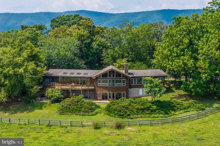 Welcome to Willardville, a one-of-a-kind Virginia farm with special history and potential. Once owned by beloved television personality Willard Scott, this 240-acre cattle and equestrian estate in Raphine is a rare offering in the Shenandoah Valley. Rolling pastures, wide-open skies, and mountain views create an inspiring backdrop for both country living and income opportunities. The custom log home spans 2,400 square feet with two bedrooms and two and a half baths. Crafted in hardwood, it features open spaces, abundant windows, and rustic elegance that blends with its surroundings. Complementing the main residence are five outbuildings. A barn includes a two-bedroom, one-bath barndominium apartment with a kitchen. A cozy one-bedroom, one-bath cabin with living room space adds charm, while two studio cottages provide self-contained living. The two-story spring house features a kitchen and living room on the main level with a bedroom and bath upstairs. All are in excellent condition with updates, offering strong potential as rentals or guest accommodations. Ideally located between Lexington and Staunton with easy access to I-81, Willardville provides both seclusion and accessibility in a truly unmatched rural setting.