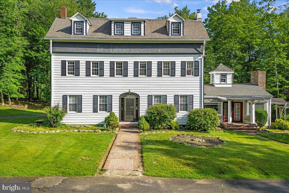 One-Of-A-Kind 10-Acre STR-Friendly Estate Across from Shawnee Ski Mountain! Frutchey Drive is a winding country road in the scenic Delaware River Valley just moments from Route 80, multiple public golf courses and the DWG National Recreation Area. This offering comprises three adjacent 3+ acre parcels - one featuring a 4,100+ sqft colonial dating to 1909 with private tennis court, the second having a smaller 1932 traditional home, and on the final parcel a massive, 15,000+(!) sqft Amish-restored barn with its own well and 2,000 gallon septic. As a country retreat, enjoy a beautiful, updated home w stream and pond, guest house, and massive storage area (think auto or tractor enthusiast) just moments from the New Jersey border. For a short-term-rental investor, find an offering unlike any other. No HOA. Great privacy. R-3 zoning for greater impervious surface coverage. Each parcel with a 14-person potential max occupancy. Main home features 5 bedrooms, beautiful original flooring, high ceilings, and huge sunken family room with fireplace, exposed beams and stone bar for an ideal game-room. Second home features private barbecue area out back and in-ground pool (in need of TLC). And the barn? Think part barndominium PLUS the wildest rain-or-shine amenity-filled space in the region - movie theater, rock-climbing wall, and foam pit! New electric, roof, windows and more already installed. This Truly Rare Opportunity Must Be Seen - Call Today to Schedule Your Private Tour!
