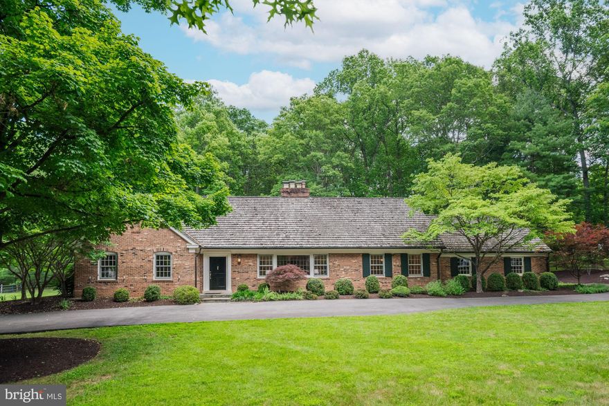 Welcome to an exceptional residence with a rich history, once owned by astronaut and Senator John Glenn. Nestled at the end of a serene cul-de-sac in sought-after Potomac Falls, this classic Cape Cod by W.C. & A.N. Miller is a luxurious private oasis waiting for you. Imagine coming home to your peaceful retreat, surrounded by nature, with a lot that's perfect for relaxing and entertaining. The main-level primary suite offers ample closet space, a dressing room, and a private en-suite bath, ensuring comfort and convenience. Gather with loved ones in the oversized family room, featuring custom built-ins, a fireplace, and sliding doors that open to the lovely back patio with a built-in fire pit overlooking the private yard—ideal for summer barbecues and quiet evenings. The eat-in kitchen, which opens to the family room, includes a workstation, a separate walk-in pantry, and access to the garage. A main-level office with built-ins and separate living spaces provides flexible options for work and leisure. Upstairs, you'll find 3 additional large bedrooms and 2 full baths, perfect for family or guests. The unfinished walk-up lower level includes the laundry room and 9-foot ceilings, offering endless potential for customization to fit your needs. This home's craftsmanship and care are evident, making it move-in ready. With the recent perc passing for 6 bedrooms, there's also the option to expand! This special opportunity is now available to you—an opportunity not to be missed!