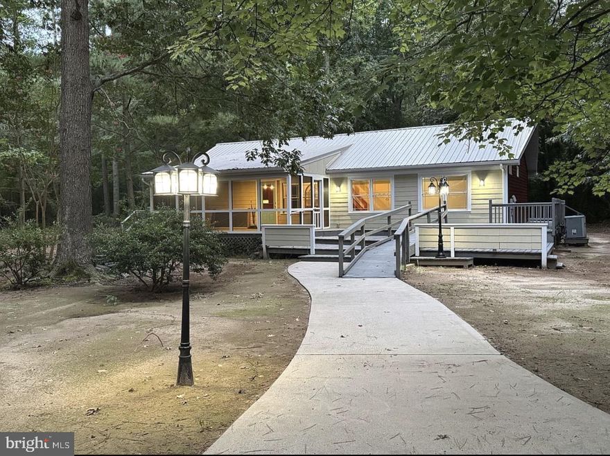 Private Woodland Retreat on Nearly 3 Acres – Beautifully Remodeled Home with Wraparound Deck, Screened Porch & Multiple Workshops

Tucked quietly among mature trees on nearly 3 private acres, this beautifully renovated home feels like your own secluded retreat. A circular gravel driveway welcomes you into the peaceful wooded setting where this thoughtfully updated 2-bedroom, 2-bath home with loft offers the perfect blend of comfort, style, and functionality.

Inside, the home has been tastefully remodeled throughout, featuring an open-concept layout with vaulted beadboard ceilings that create a bright and inviting living space. The beautifully designed kitchen offers solid surface countertops, custom cabinetry with built-in organizational features, subway tile backsplash, stainless appliances, and generous workspace, making it perfect for both everyday living and entertaining.

The home also features beautifully renovated bathrooms completed from the floor up, showcasing luxury flooring, modern fixtures, and thoughtfully designed finishes that provide both style and comfort and a new Rinnai tankless hot water heater, providing modern efficiency and convenience.

Step outside and enjoy the peaceful setting from the large screened porch and expansive wraparound deck, ideal for relaxing, hosting gatherings, or simply enjoying the privacy and natural beauty that surrounds the home.

The property truly shines for those needing additional space or hobbies, offering two workshops, a garage, and an additional storage shed, providing incredible flexibility for projects, storage, or creative pursuits.

With nearly 3 acres of land, multiple access points from both Grandy Lane and Walt Thomas Drive, extensive upgrades, and a serene park-like setting, this unique property offers a rare opportunity for private, move-in ready living with room to spread out and enjoy nature