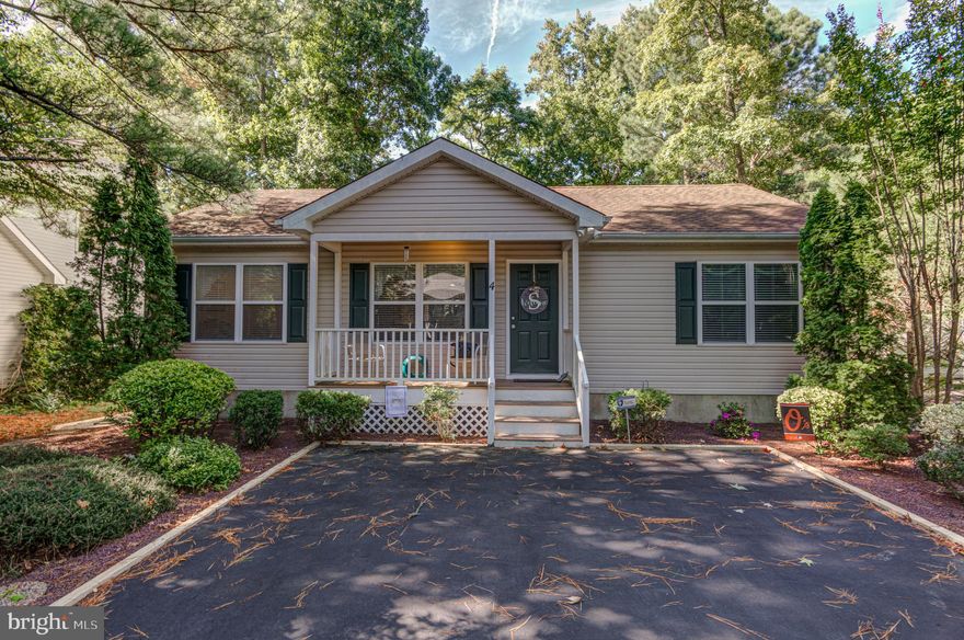 Picture perfect custom-built 3-bedroom 2 bath contemporary home with a large, screened porch that overlooks a private rear yard with a patio for outdoor enjoyment. Split bedroom floor plan is very desirable to owners and guests. Sold completely furnished expect for the few items on the Inventory List. LVP and Hardwood floors in the living areas and carpet in the bedrooms. Tile entry foyer. Detached vinyl shed is perfect for bikes, beach toys and tools. Convenient Outdoor Shower for a quick rinse off after a trip to the beach or pools. Location on a short cul-de-sac street convenient to the South Gate and The Yacht Club or Golf course Country Club. Extensive landscape work just completed. Easy to see. Stop by and fall in love.