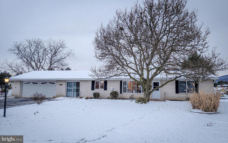 All-brick rancher with over 2600 finished square feet of living area on 1/3+ acre located in popular Smithsburg! Convenient main level living spaces include kitchen with prep island, living and dining rooms (with access to the rear patio), three bedrooms and two full baths (both updated in previous years) including a private en suite bath for the primary bedroom. There is a fully enclosed breezeway with entrances to both the front and rear yards, and currently houses an expanded laundry area and a home office space. This is an excellent home for entertaining friends and family, with ample parking, a huge 800+ sq ft finished rec room in the lower level, and a generous 30' long covered rear patio adjacent to the fully fenced backyard -- WITH mountain views -- great spaces move-in ready for parties and cookouts! Hobbyists, tinkerers, and collectors will appreciate the oversized two-car attached garage, and the 700+ sq foot lower level workshop with an extra-wide exit door to the rear yard. Add to all this a brand NEW roof, the cozy ambience of a large fireplace on the main level and a bonus fireplace in the lower level rec room,  and you can't help but see the excellent value of this home. Don't miss this one!