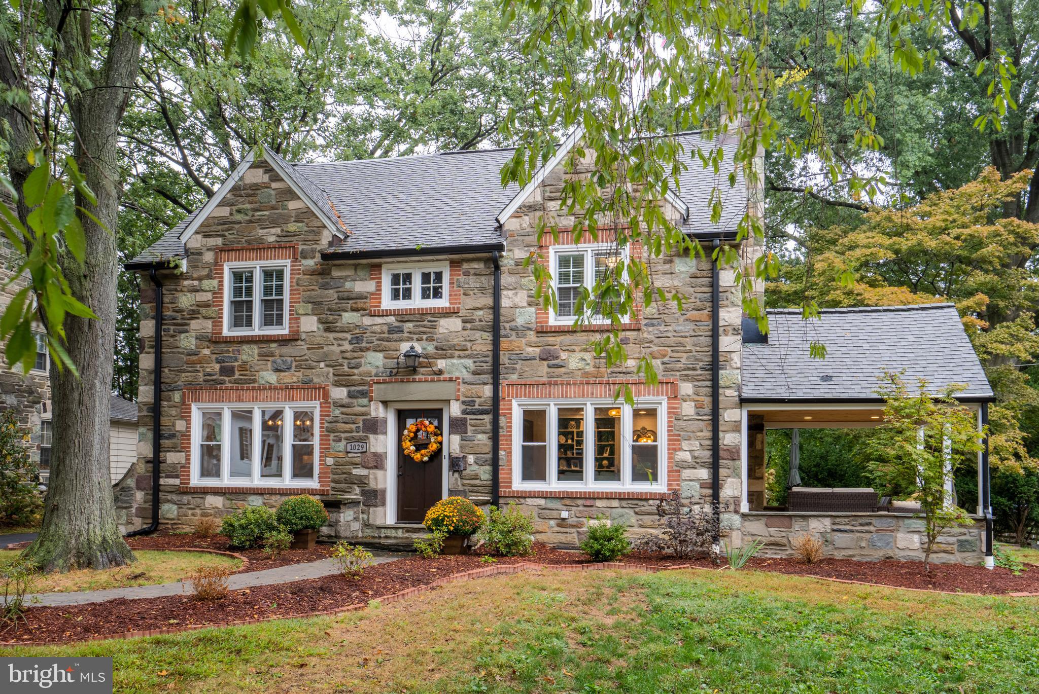 This beautifully crafted Lower Merion Home is set on a quiet, beautiful street with towering trees and delightful landscaping featuring colorful perennials, mature shrubbery and  brick pavers surrounding the flower beds. This home was completely remodeled  i n early 2018 and the basement was finished in 2019. Charm abounds inside with hardwood floors in most of the rooms, shiplap accents throughout ,deep window sills, handsome builts-ins & a wood burning   fireplace . The new kitchen sparkles w/white cabine  try & soft-close drawers, stainless steel appliances ,        custom kitchen island , marble tops & a tile backsplash. Large living & dining rooms w/bay windows to bring the outside in. The master suite is equipped with his & her closets and a remodeled bathroom w/ tiled shower and dual shower heads. Three other nice- sized bedrooms are located on the second floor with a beautiful updated full bathroom . A gorgeous paver patio adjoins the side porch for outdoor relaxing or entertaining . Other features include the 3rd floor bonus room w /powder room for guest suite, office etc.  The basement was finished January 2019 ., with a  laundry room,  entertainment area and full bathroom . Prime location just steps away from Wynnewood train station, minutes to local schools , major roadways , shopping  & more .