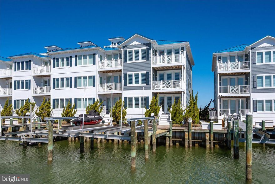 Stunning Corner Waterfront Townhome in West Ocean City hits the market! This exquisite 4-bedroom, 4-bathroom corner unit townhome with garage and boat slip with 24,000 lb. lift offers unparalleled waterfront living in the heart of West Ocean City.  Boasting breathtaking water views, this home perfectly blends luxury with convenience, making it an absolute must-see.  On the first level, you’ll find an oversized bedroom with a full bath and sitting area with fireplace, offering direct access to a private deck overlooking the water. This floor also features a laundry room. The garage provides direct access to this level, with either an elevator or stairs taking you up to the second and third floors. The second floor presents a spacious family room and dining area, complete with a fireplace for year-round enjoyment. This home is perfect for entertaining family and friends. The upgraded kitchen boasts granite countertops, stainless steel appliances, and plenty of storage space.  A second deck on this level offers additional outdoor space with lovely water views. Also located on this floor is a second bedroom and full bath. The home features luxurious LVP flooring, carpet, tile and plantation shutters adorn the windows.  On the third level, the luxurious primary suite awaits with a walk-in closet, a spa-like bath with a stall tile shower and a jetted tub, plus a private balcony to enjoy the stunning views. Another bedroom with a private bath and balcony completes this floor. The complex also includes a pool for added relaxation. Step outside onto your own private deck to take in the beautiful surroundings or take full advantage of the 24,000 lb. boat lift and slip out back.  (2HVAC Systems were replaced in 4/2021 and has a 7-year transferable warranty, water heater was 2017.) Whether you’re an avid boater or simply want to enjoy the tranquility of waterfront living, this townhome offers it all.  Conveniently located just minutes from Ocean City’s famous beaches, dining, shopping, and entertainment, this property combines the best of waterfront living with access to all the excitement of nearby attractions. Don’t miss out on the chance to own a piece of paradise!