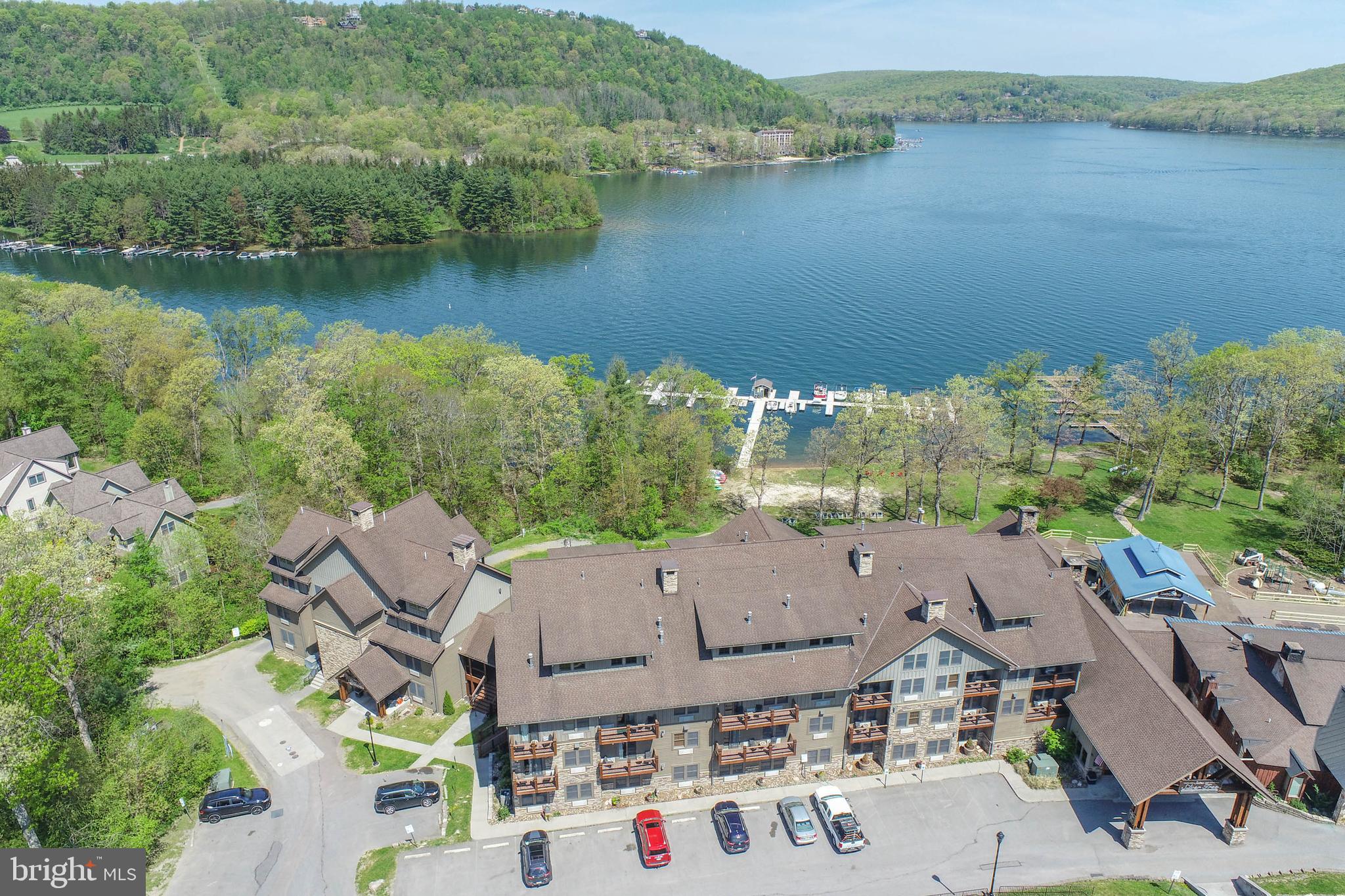 Experience effortless lakeside living at its finest in this spacious 2-bedroom, 1-bath unit in Silver Tree Suites—one of the largest units in the complex! This beautifully designed unit features an open floorplan centered around a cozy fireplace, perfect for relaxing after a day on the lake. A generous loft area creates a distinct separation between living and sleeping spaces, offering flexibility and privacy. Take in views of Deep Creek Lake and just a stones throw from your door, enjoy unbeatable proximity to Dutch’s at Silver Tree and The Harbor Bar. Whether you're looking for a weekend retreat or a hassle-free getaway, this turnkey condo is truly maintenance-free—just drop your bags and start enjoying lake life!