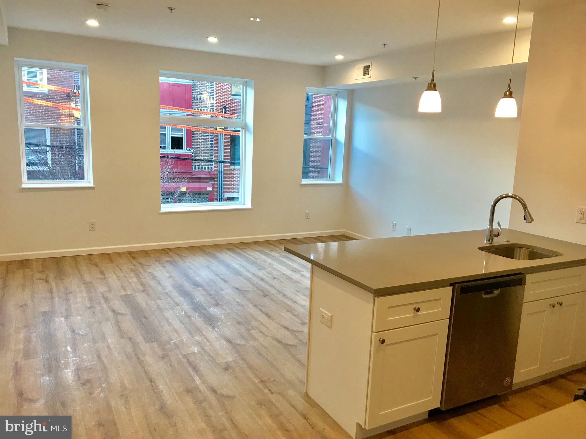 Beautiful, Bright, and spacious 2 bedroom apartment home with luxury finishes throughout! Natural wood color luxury plank flooring, high ceilings, large windows that let in a ton of natural light, open living space with modern kitchen cabinets, quartz counters, breakfast bar, stainless steel appliances, energy efficient LED lighting throughout, and much more! Amazing Fabric Row location close to shops, restaurants, public transportation, and everything else you need to live your best life!