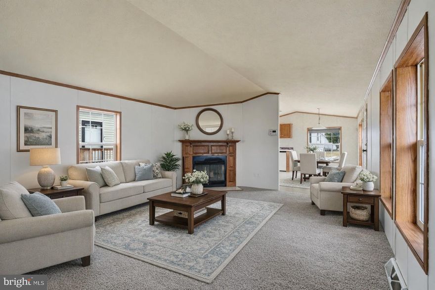 Welcome to this lovely 21 year young home in the "land of simple living" (Winterset farms Manufactured Home Community).  Step up into this lovely home via the freshly painted covered deck. The large front kitchen has plenty of cabinets and counter space and is extra bright with its skylights and windows. Microwave built in over stove (all appliances are included).  The spacious Living room boasts a wood burning fireplace. Down the hall are 2 bedrooms and a full bath and also a convenient laundry area (washer and dryer are included). House has been freshly painted and carpet is new. Great, clean house at a competitive price! Shed is also included. Come see! (Disclosure: Living room is virtually staged).
(Manufactured home loans are acceptable but homes not eligible for a mortgage since it is a lot lease and you do not own the land.)